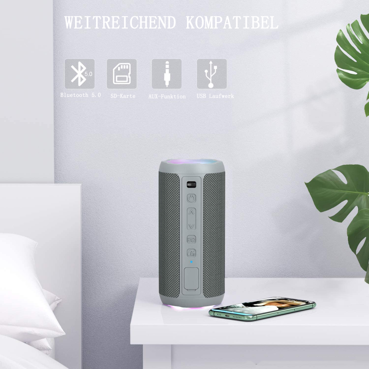 Ein grauer Lautsprecher auf weißem Untergrund mit dem Text "WEITREICHEND KOMPATIBEL" und Symbolen.