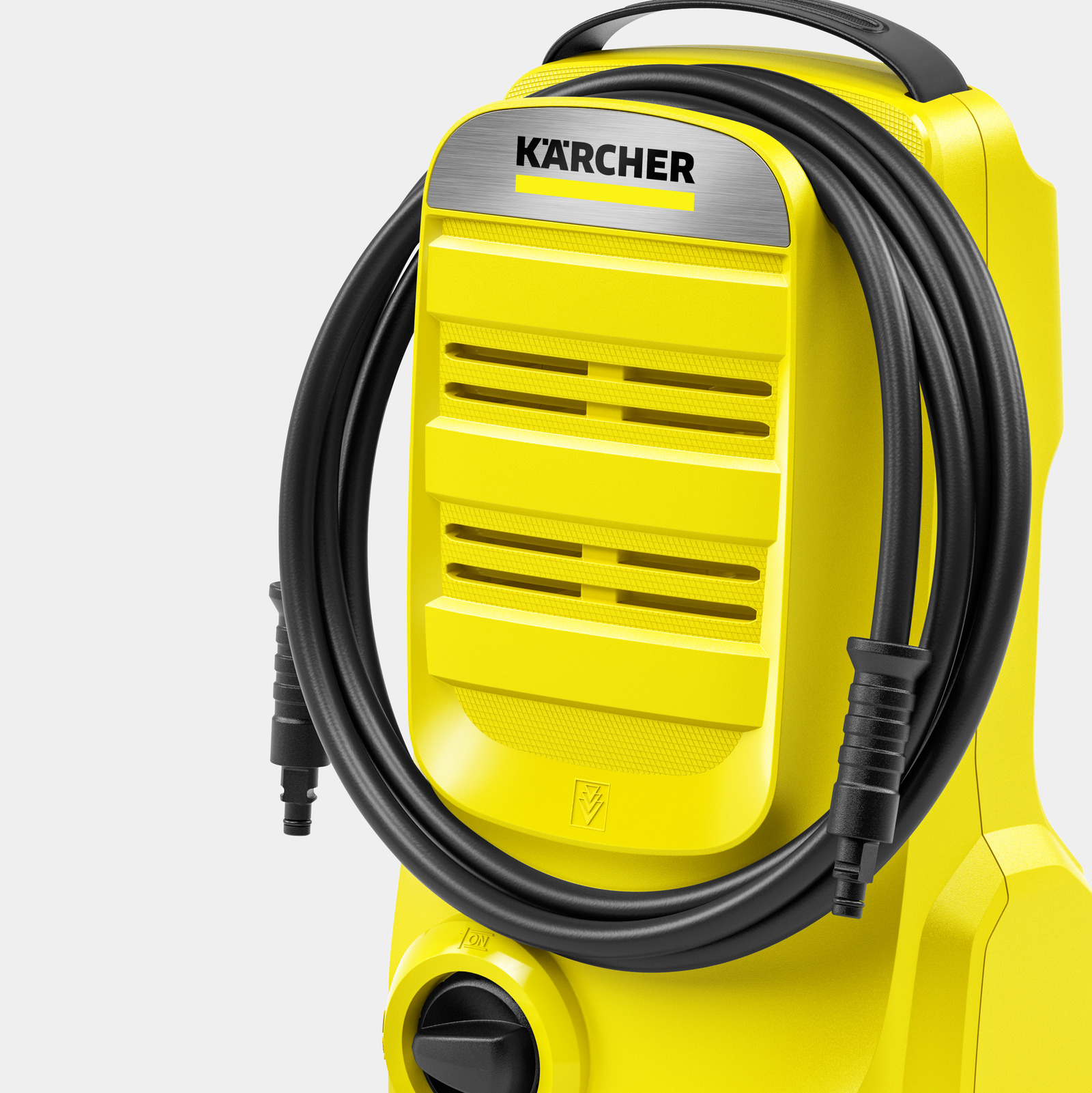 Żółta myjka ciśnieniowa Karcher z czarnym wężem i uchwytem.