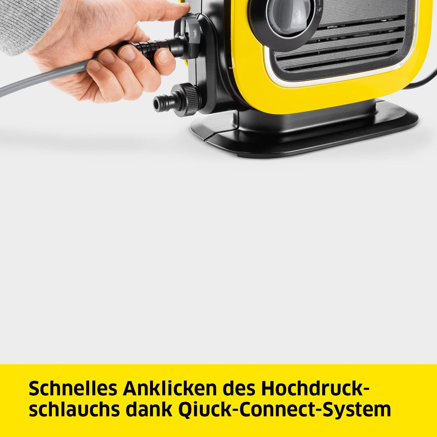 Nahaufnahme einer gelb-schwarzen Maschine mit angeschlossenem grauen Schlauch. Text: Schneller Anschluss mit Quick-Connect-System.