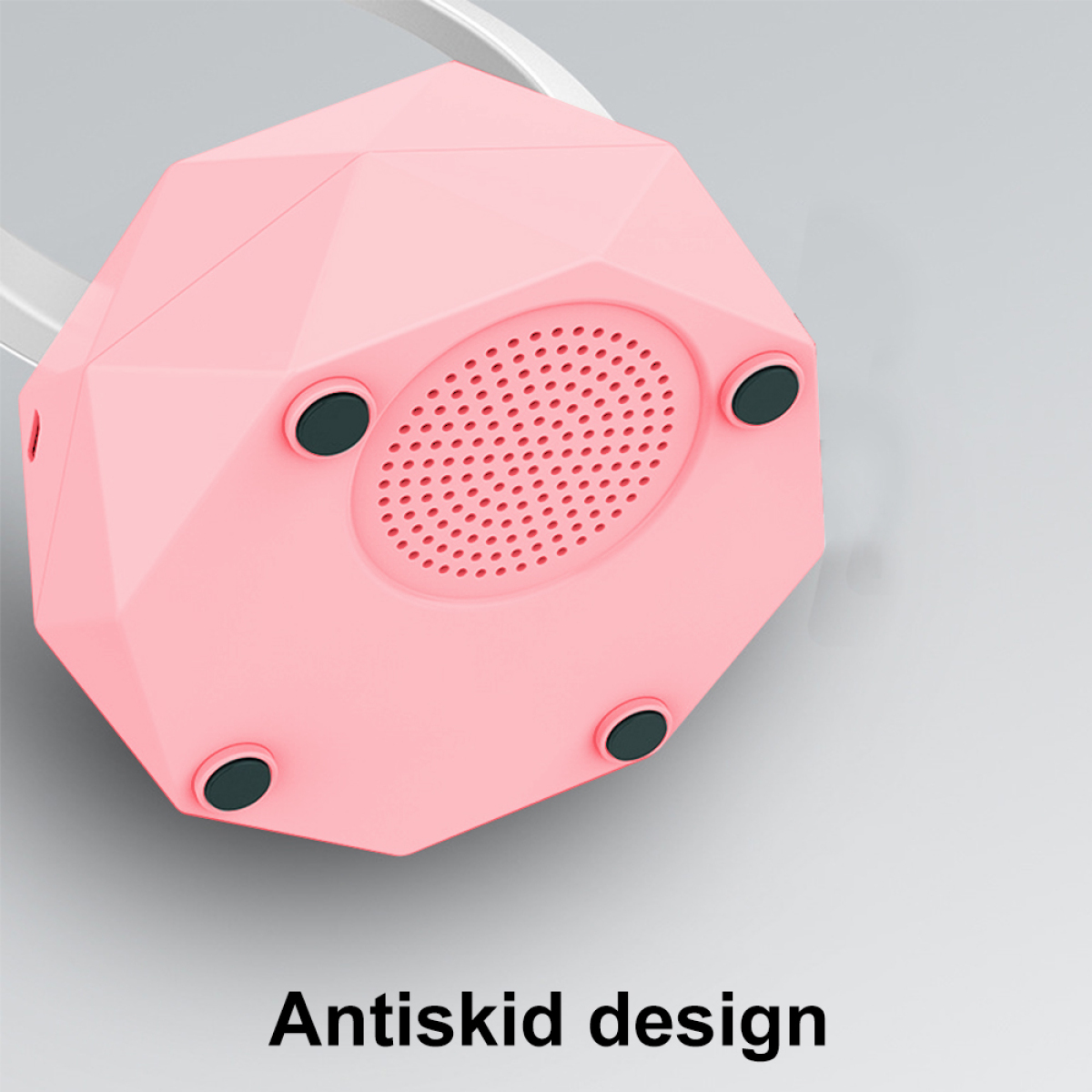 Rosa Lautsprecherbasis mit schwarzen Füßen und dem Wort 'Antiskid design'.