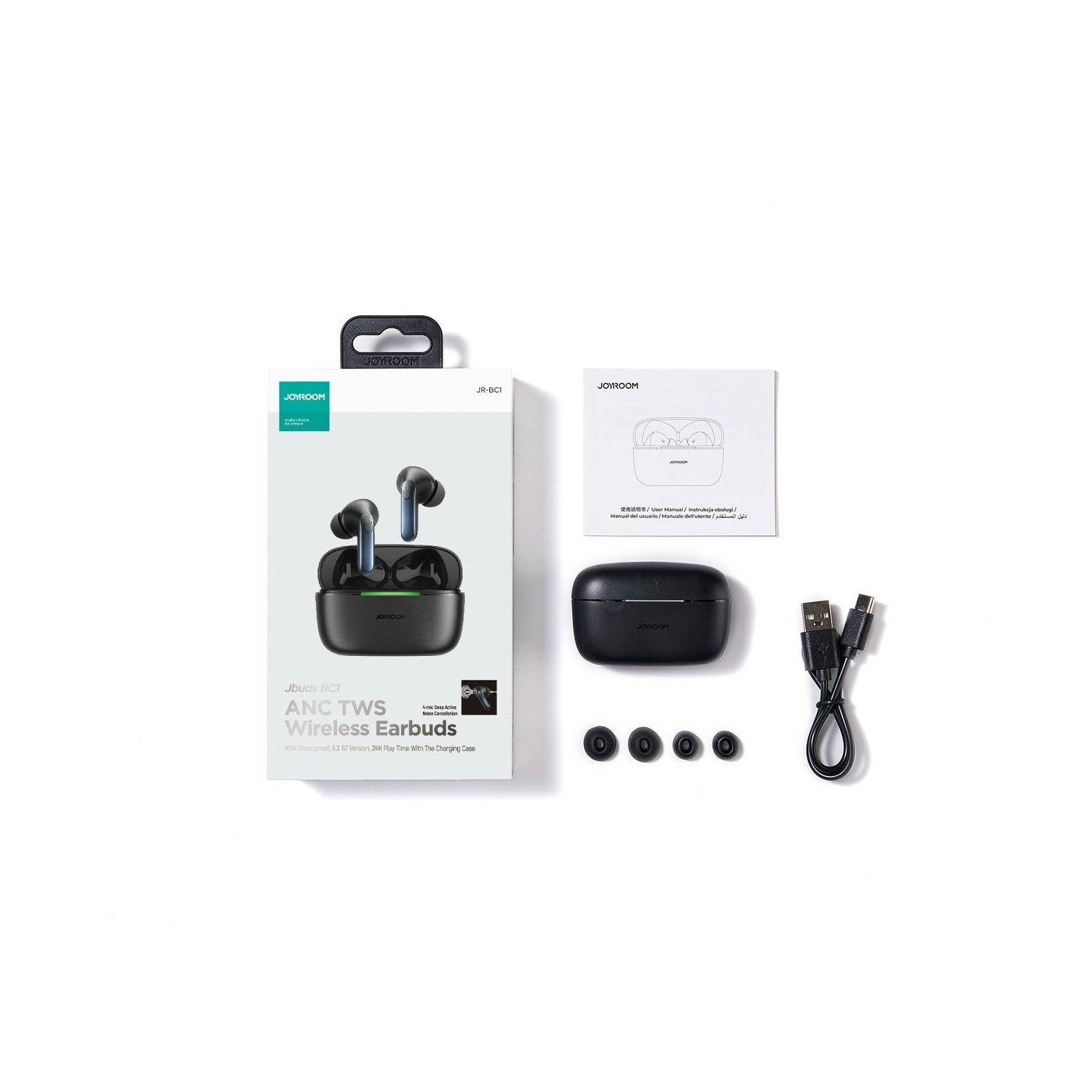 Opakowanie słuchawek z akcesoriami: etui, dodatkowe końcówki i kabel ładujący, wszystko na białym tle.