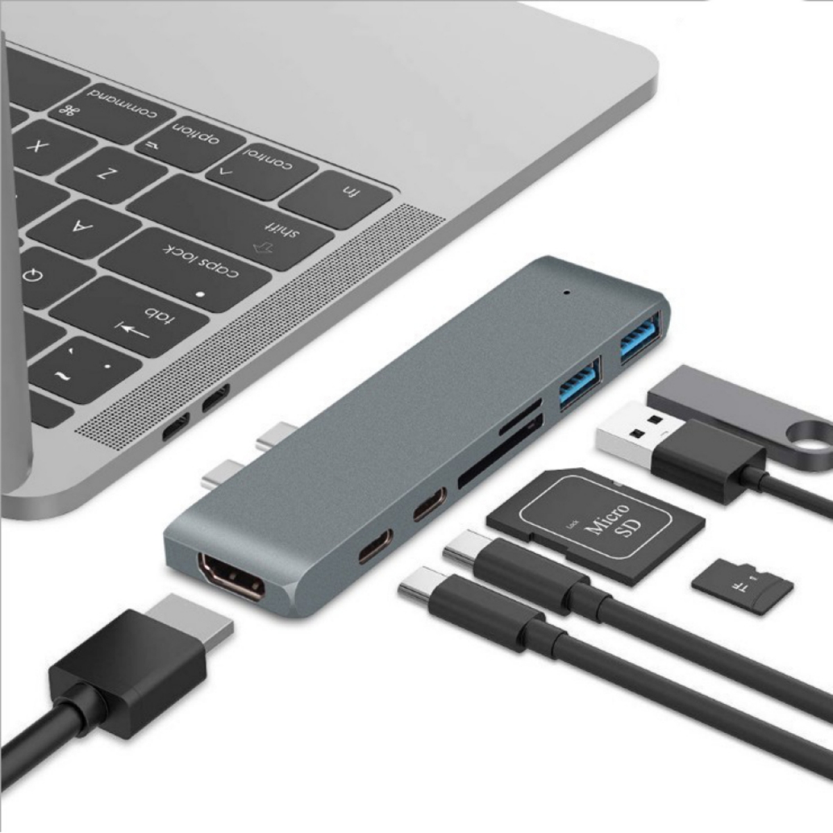 Ein grauer Hub mit Anschlüssen und einem Laptop, mit Kabeln, SD-Karte und USB-Stick.