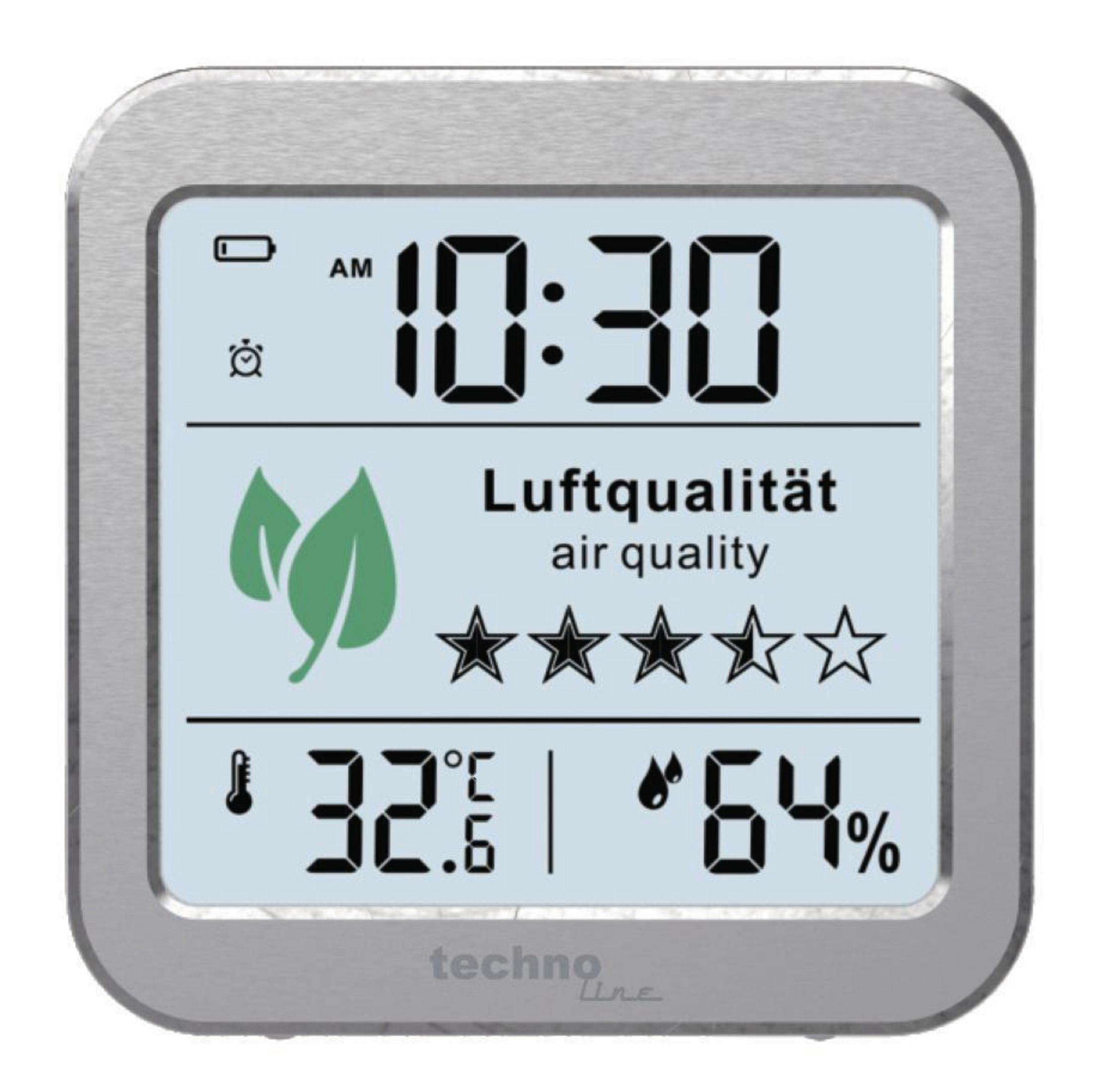 Wyświetlacz cyfrowy pokazujący czas, jakość powietrza i temperaturę w kwadratowej srebrnej ramce.