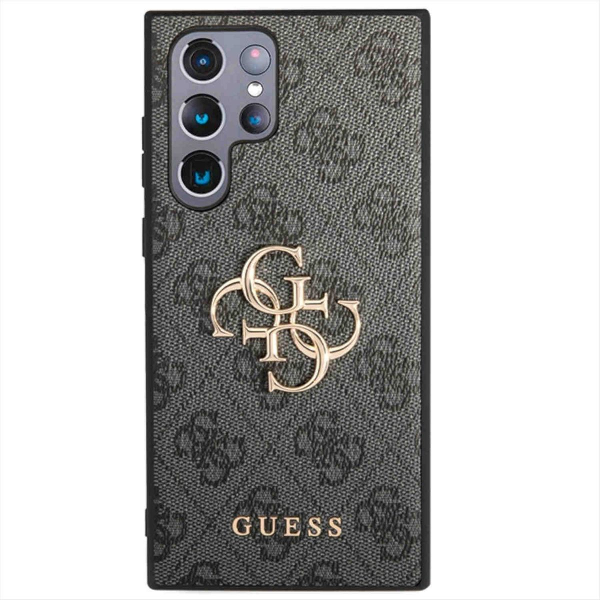 Una custodia per telefono con un motivo nero e grigio con il logo Guess in oro.