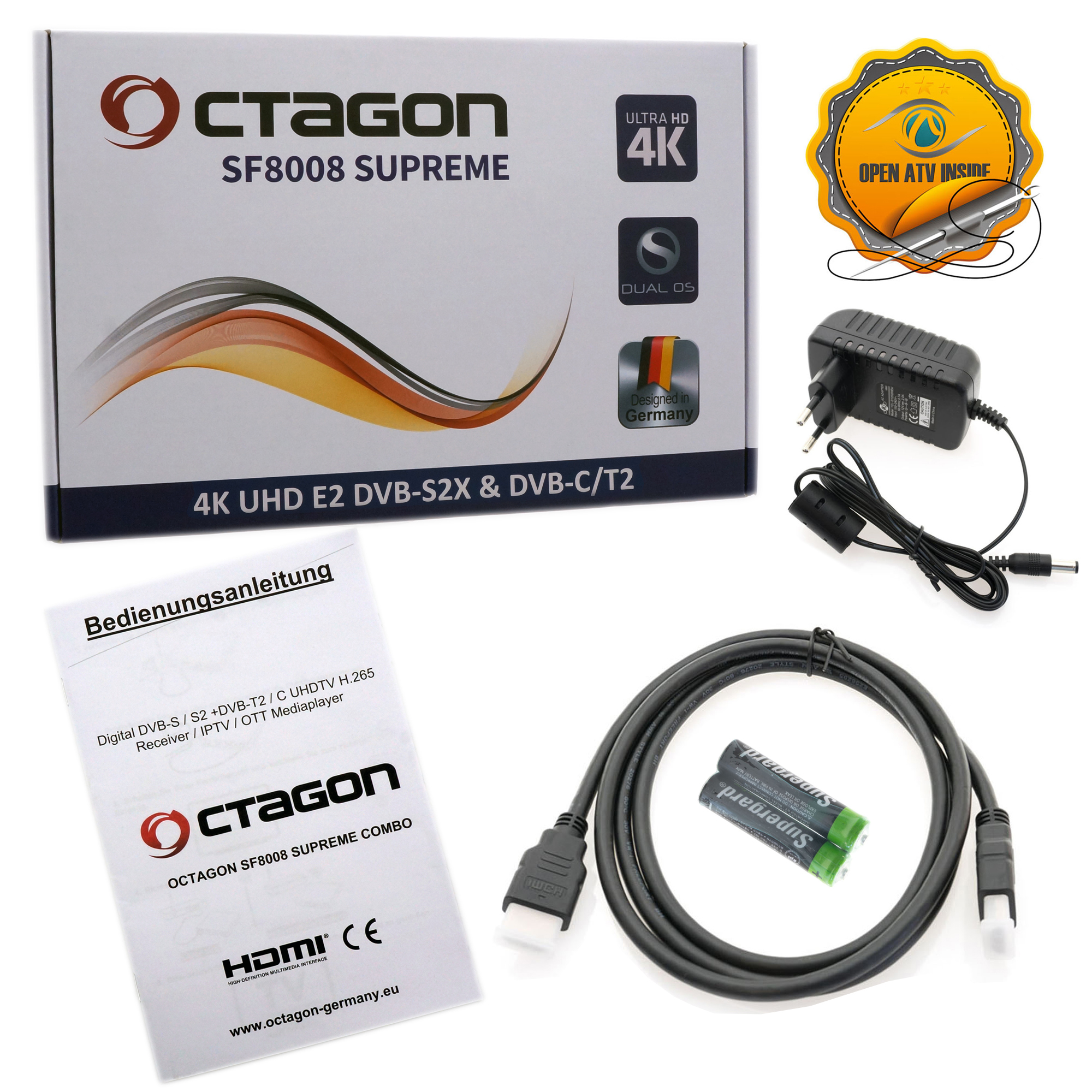 Box mit Satellitenreceiver, Netzteil, Kabeln und Fernbedienung. Die Box hat Text.