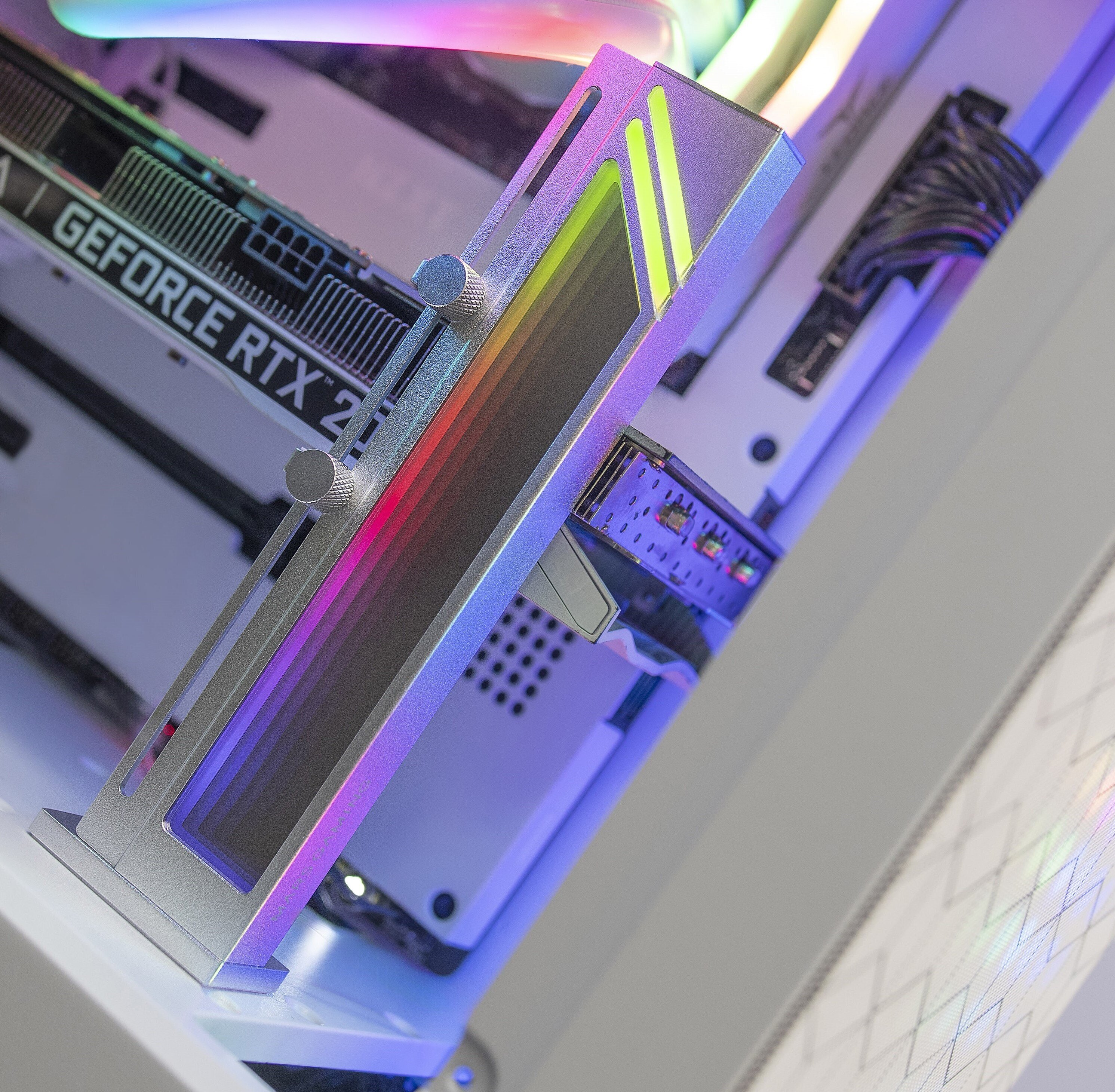 Componente de computadora plateado con luces de colores y dos perillas de ajuste.