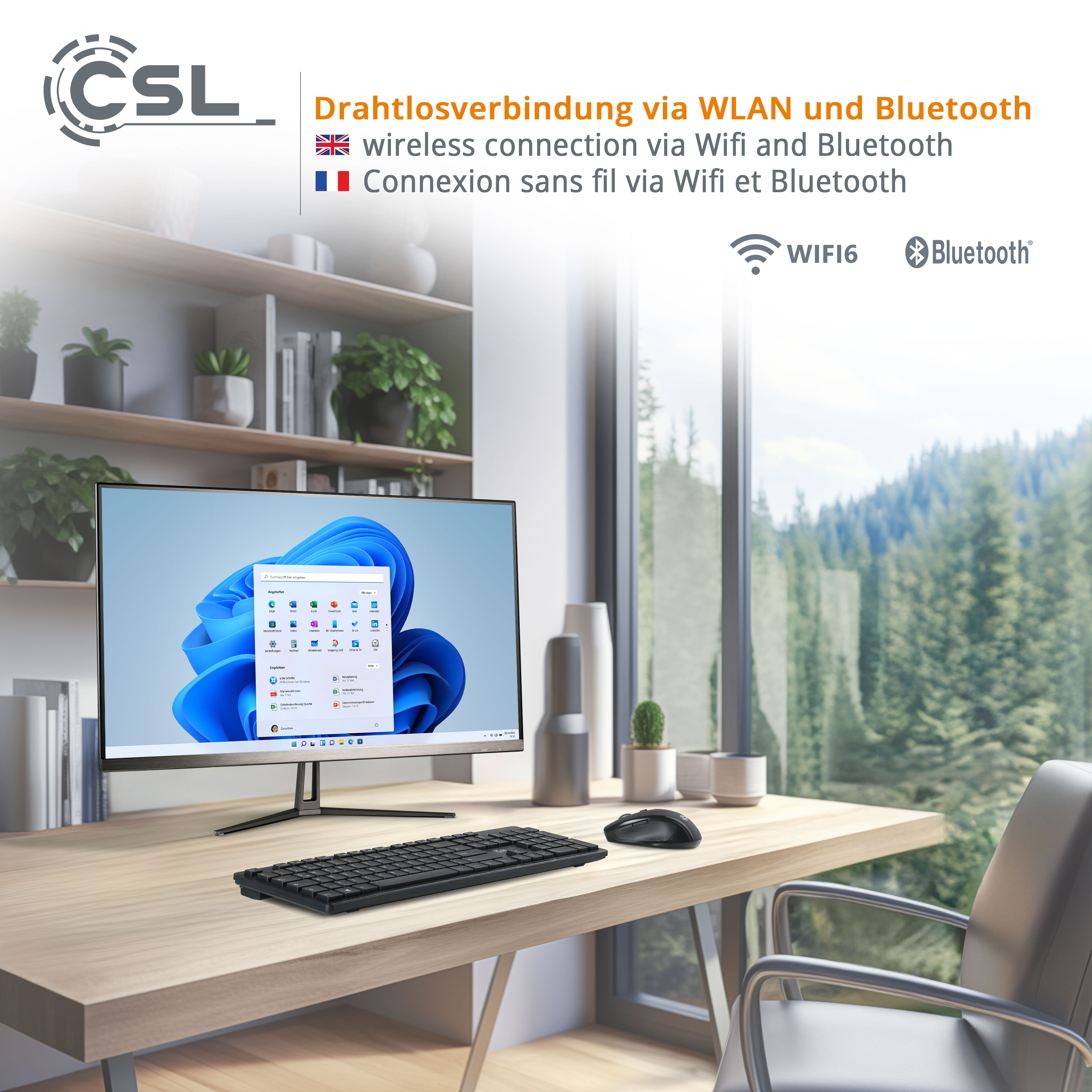 Ein moderner Schreibtisch mit Computer, Tastatur, Maus und Fenster mit Waldblick.