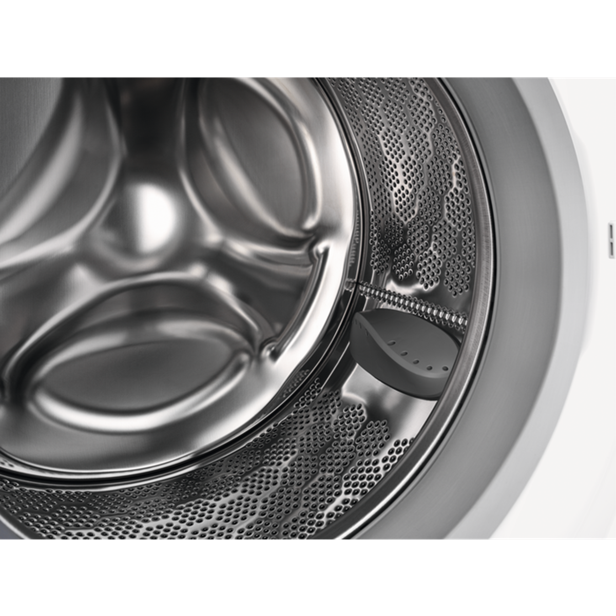 Close-up of a washing machine drum, showing the stainless steel interior.