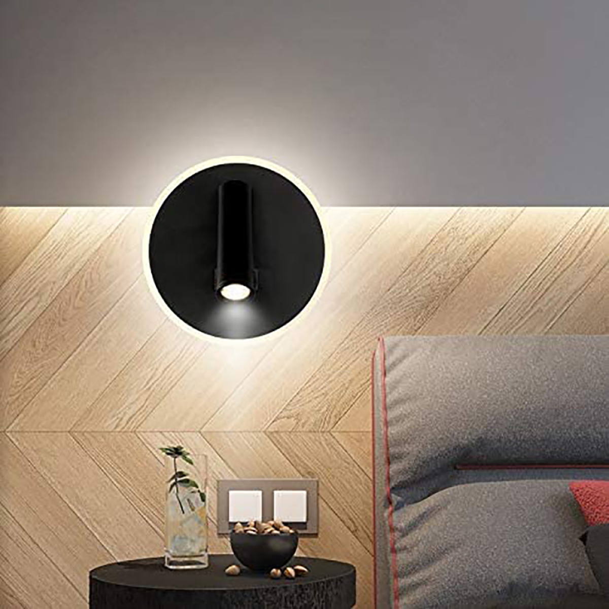 Eine schwarze Wandlampe mit rundem Design und Lichtstrahl.