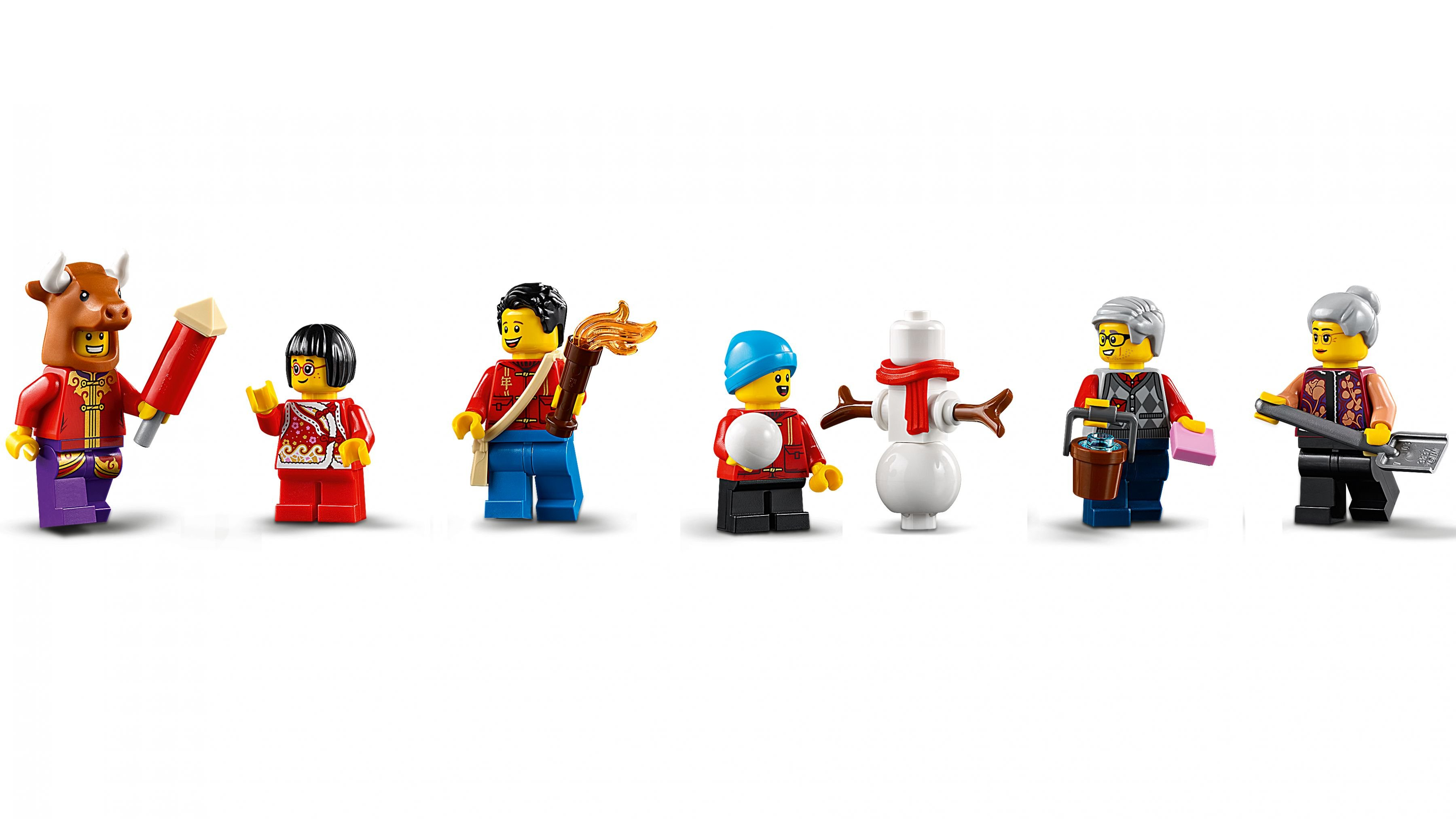 Şenlik kıyafetleri giymiş Lego figürleri. Biri boğa kostümlü, diğerleri hediye ve aksesuarlarla.