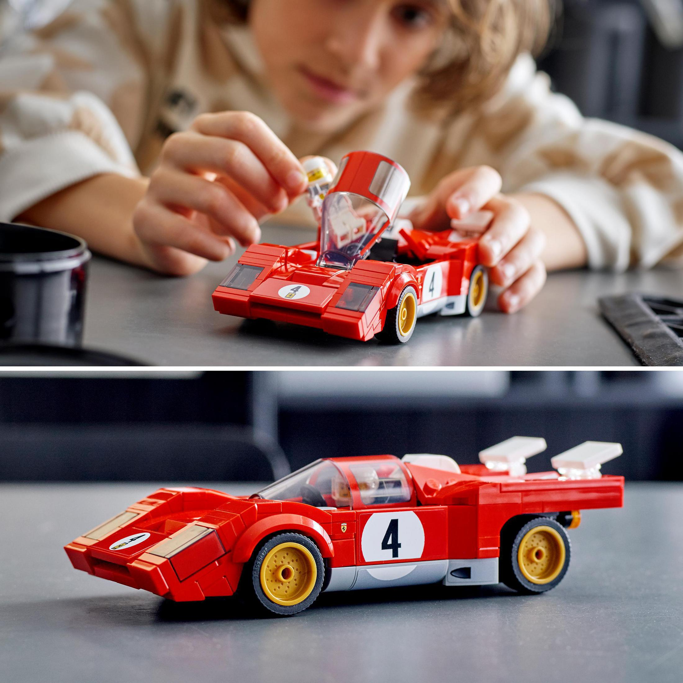 Ein Kind spielt mit einem roten Lego-Rennwagen. Detailliertes Modell mit gelben Rädern und der Nummer 4.