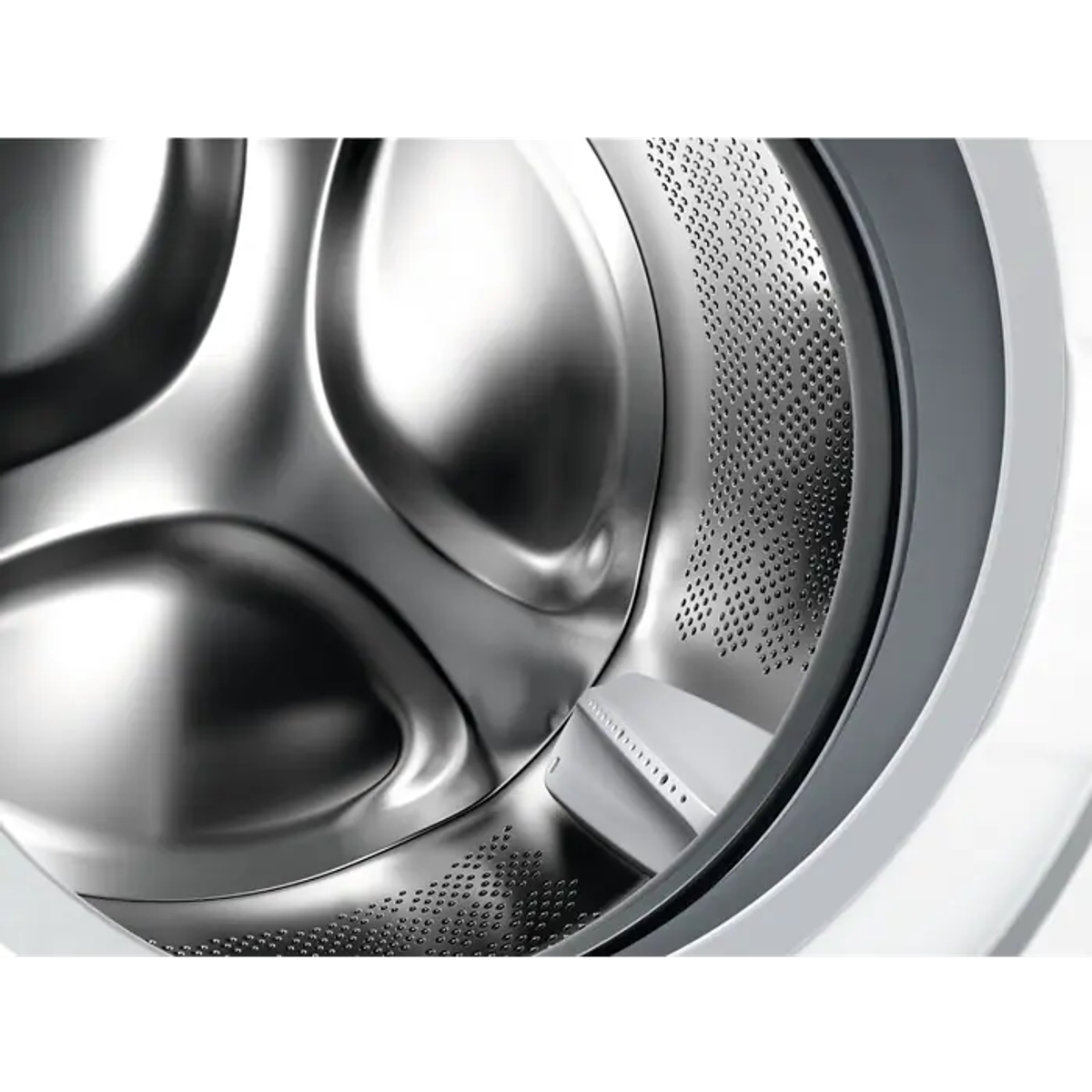 Zbliżenie bębna pralki, z perforacjami na metalowej powierzchni.