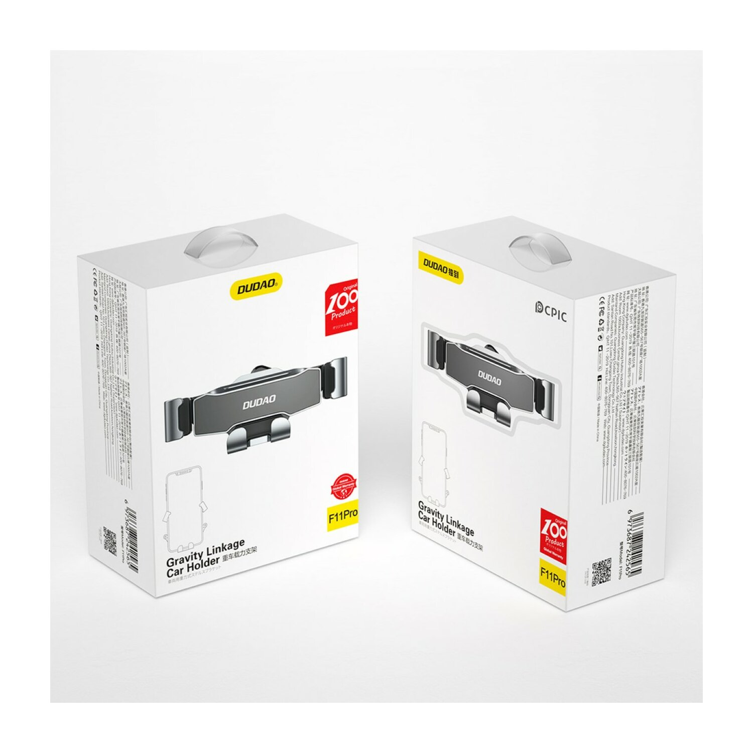 Dwa białe pudełka z uchwytem do telefonu samochodowego w środku. Uchwyt jest szary i czarny.