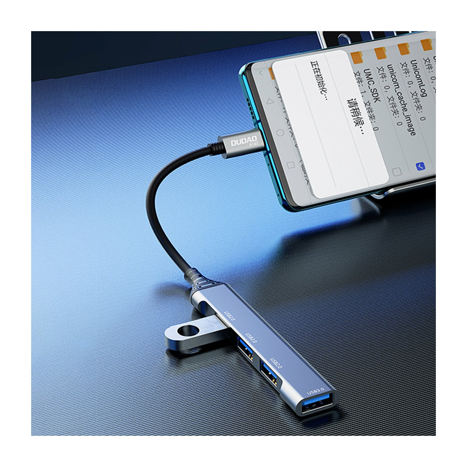 Un telefono è collegato a un hub USB. Lo schermo del telefono mostra un menu file. Lo sfondo è un tavolo blu.