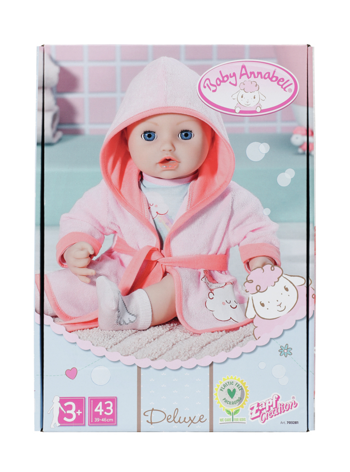 Eine Baby Annabell Puppe in einem rosa Bademantel sitzt in einer Box. Die Box hat Illustrationen eines Babys.