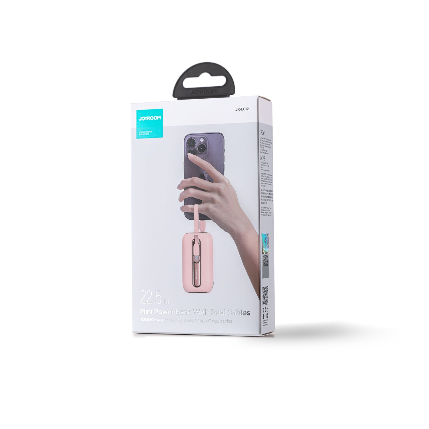 Różowy mini power bank z kablami, w pudełku. Ręka trzyma telefon z bankiem na pudełku.