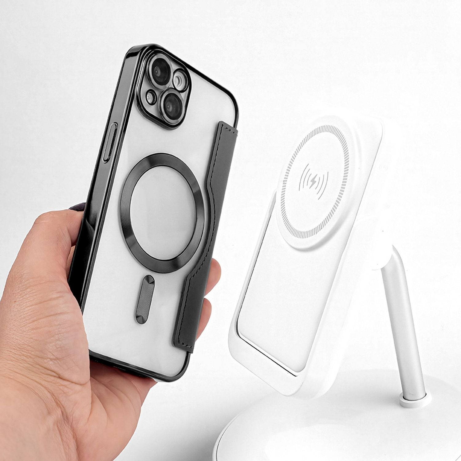 Custodia nera e trasparente con anello magnetico. Caricatore wireless bianco sulla destra.