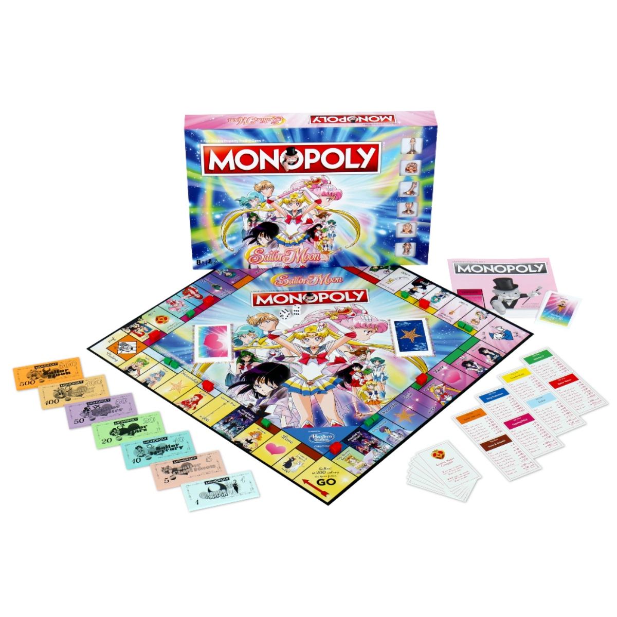 Scatola e componenti del gioco Monopoly di Sailor Moon. Il tabellone è visibile.