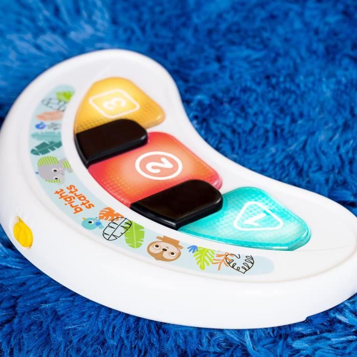 Weißes Spielzeug mit bunten Knöpfen. Die Zahlen 2, 3 und 7 werden angezeigt. Der Hintergrund ist blau.
