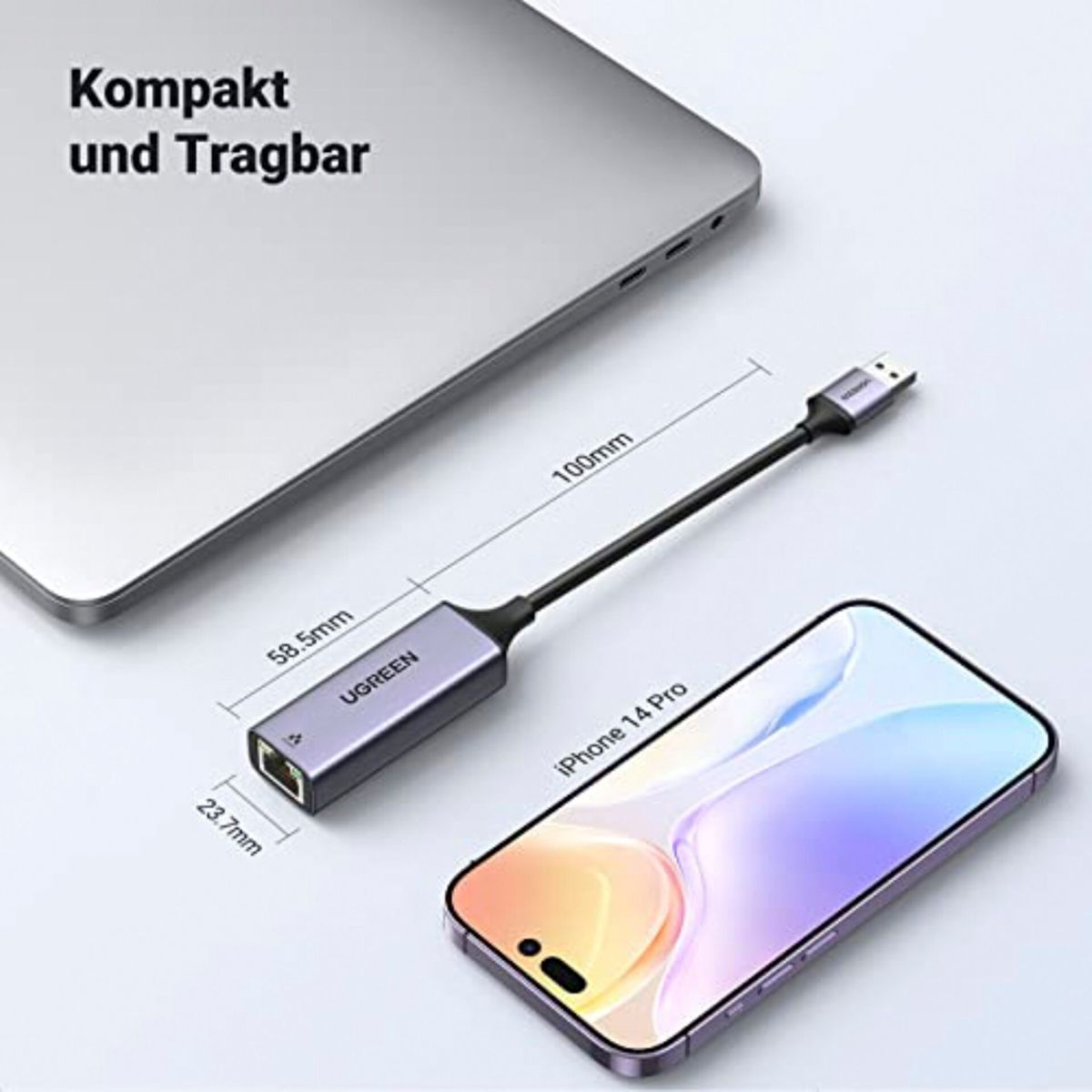 USB-C konektörlü ve Ethernet portlu gümüş UGREEN adaptör, bir iPhone ve dizüstü bilgisayarın yanında.