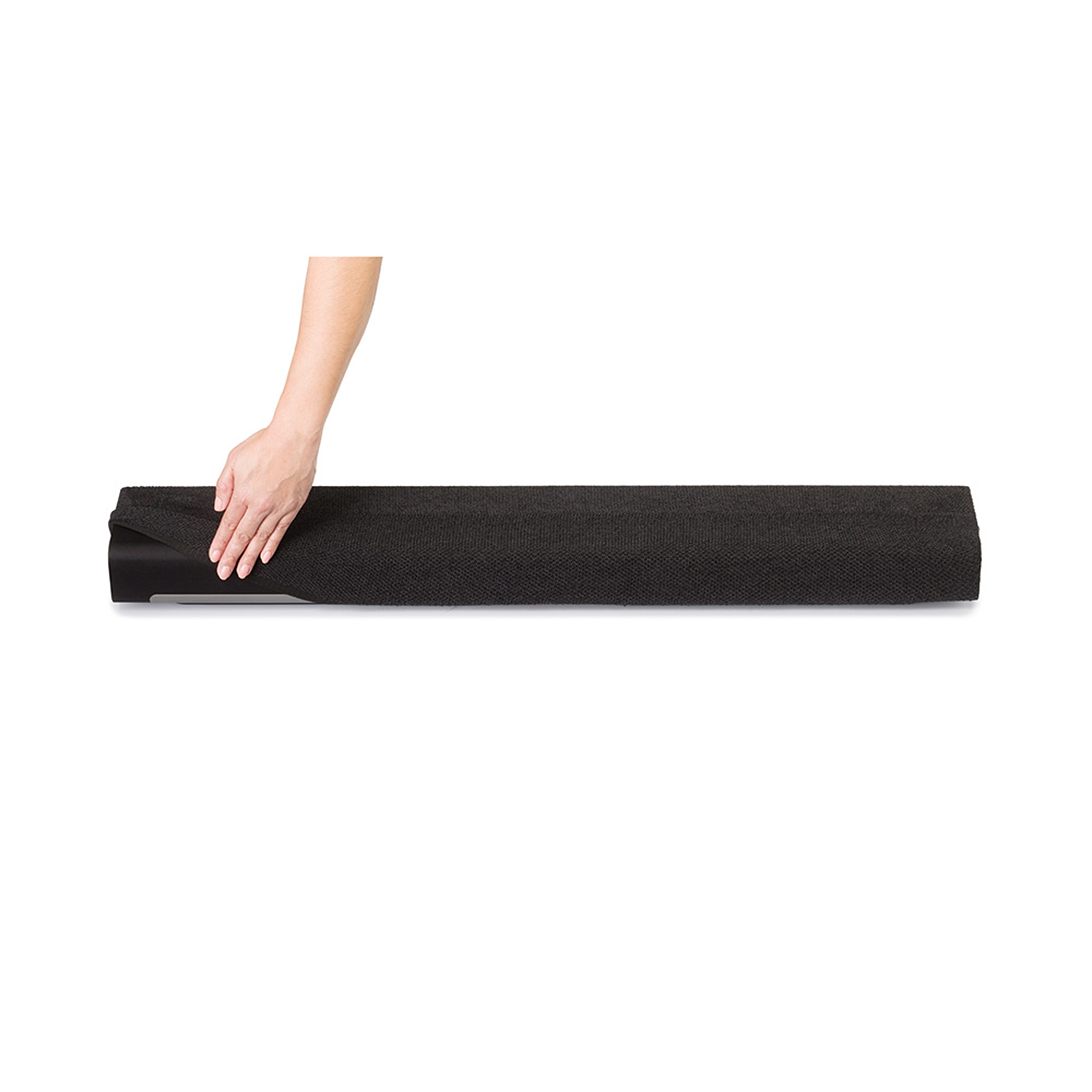 Une main enroulant un tapis noir texturé.