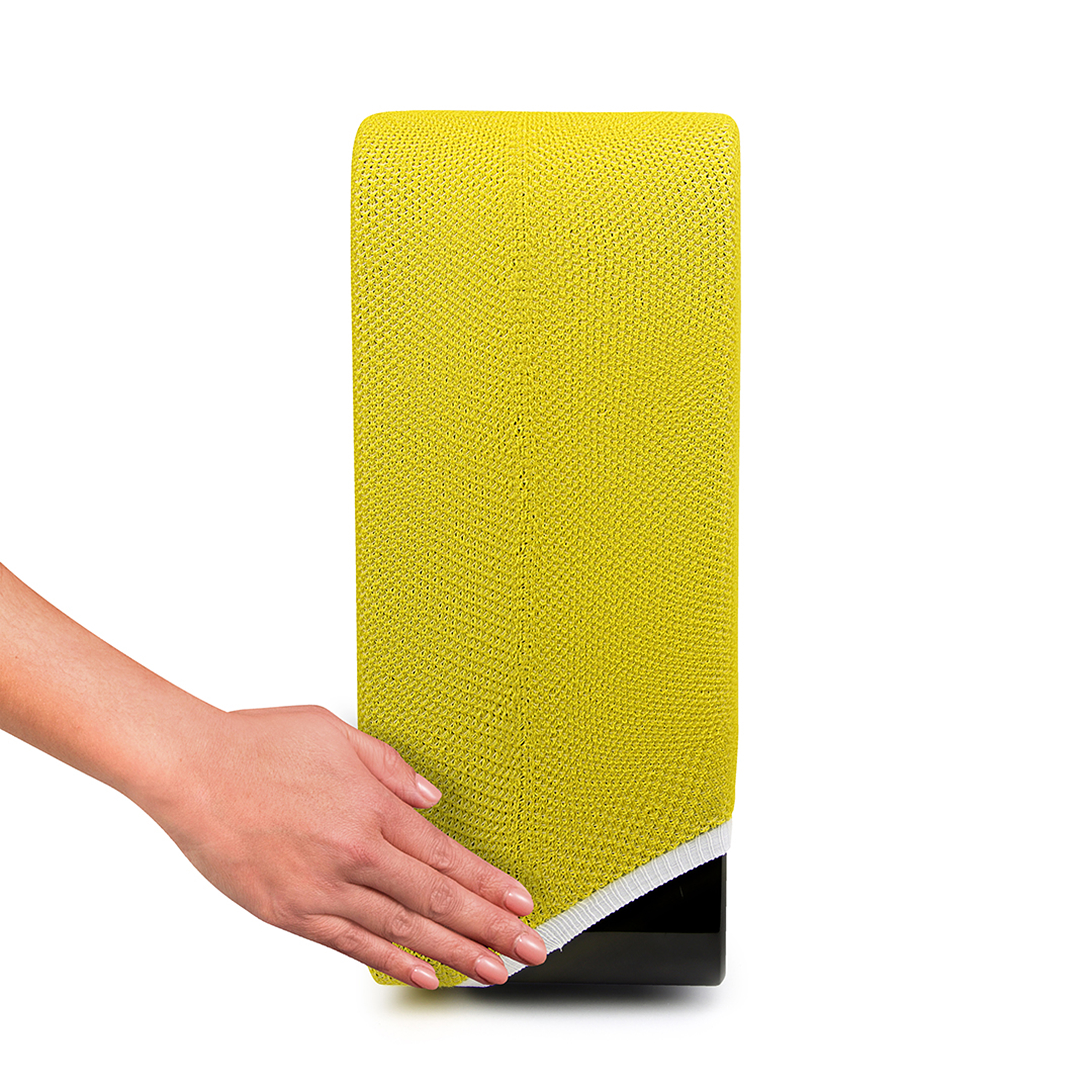 Main touchant un bloc rectangulaire jaune tricoté sur fond blanc.