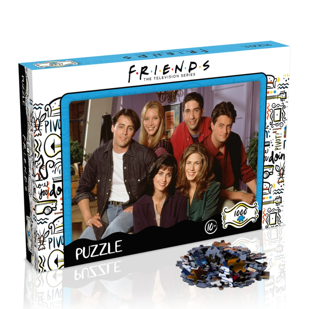 Eine Friends-Puzzledose zeigt die Besetzung in einem Wohnzimmer. Ein Stapel Puzzleteile liegt davor.