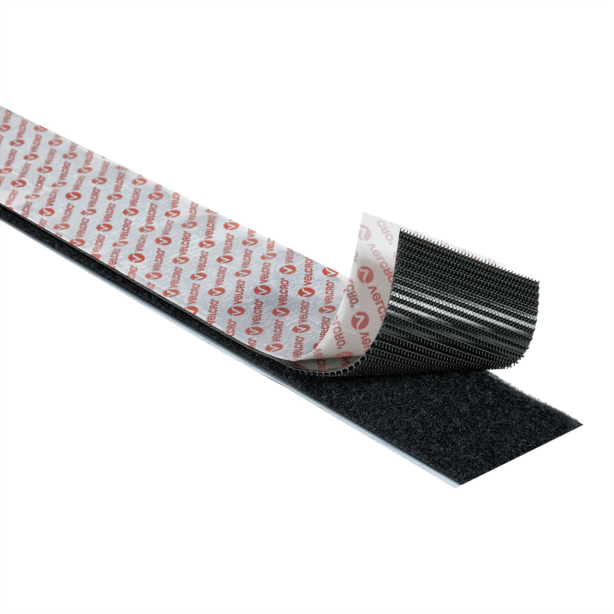 Zwarte klittenbandstrips. Eén strip met witte achterkant, losgemaakt.