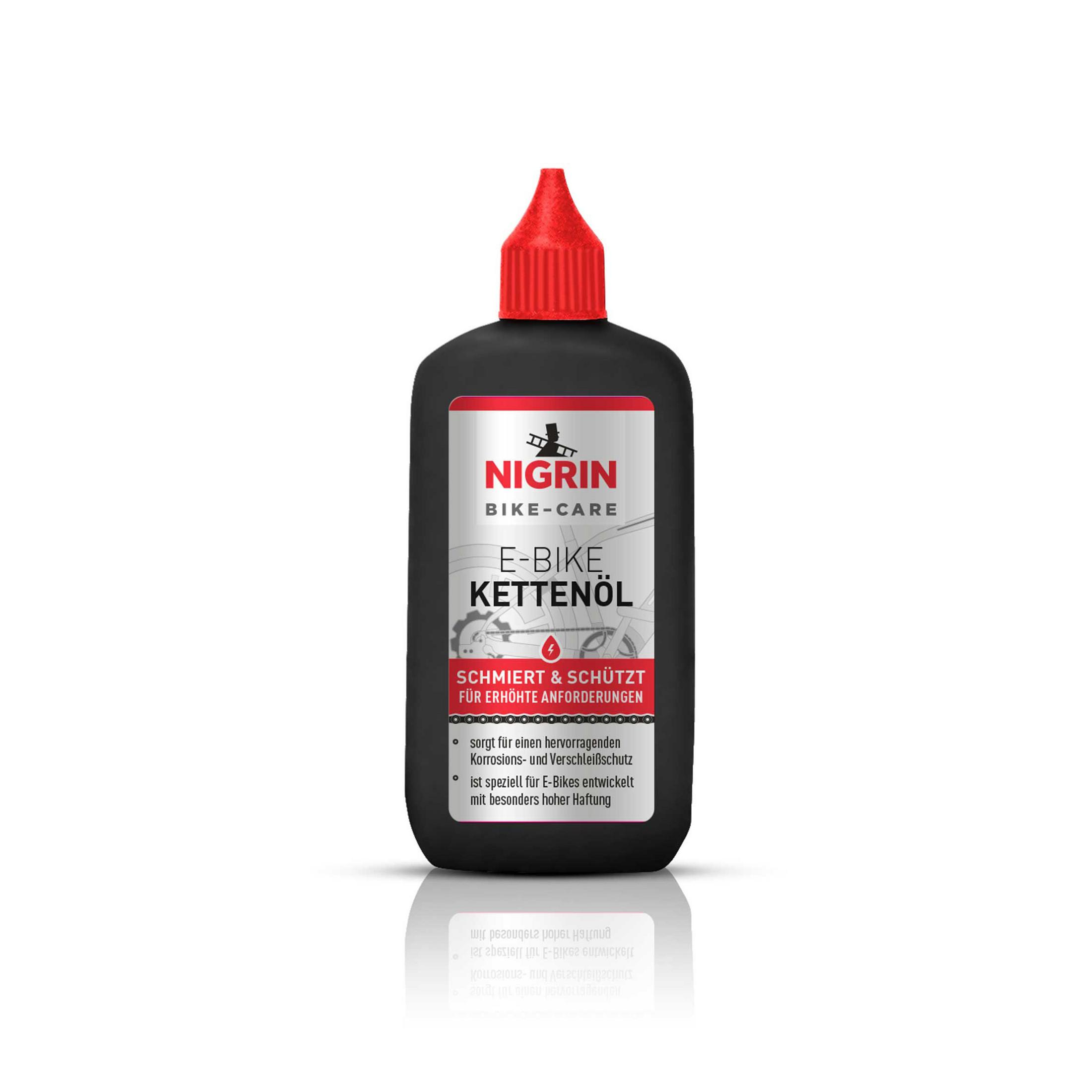 Schwarze Flasche Nigrin E-Bike Kettenöl. Roter Deckel, schwarzes Etikett mit weißem und rotem Text.