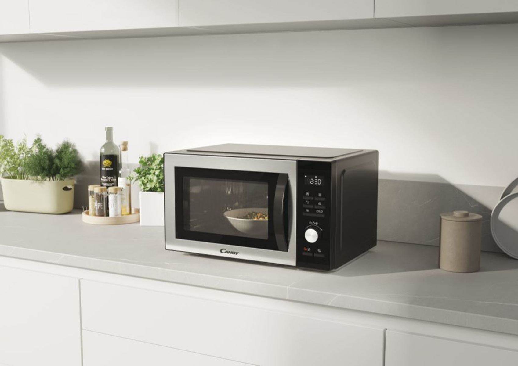 Czarna kuchenka mikrofalowa na białym blacie w nowoczesnej kuchni.