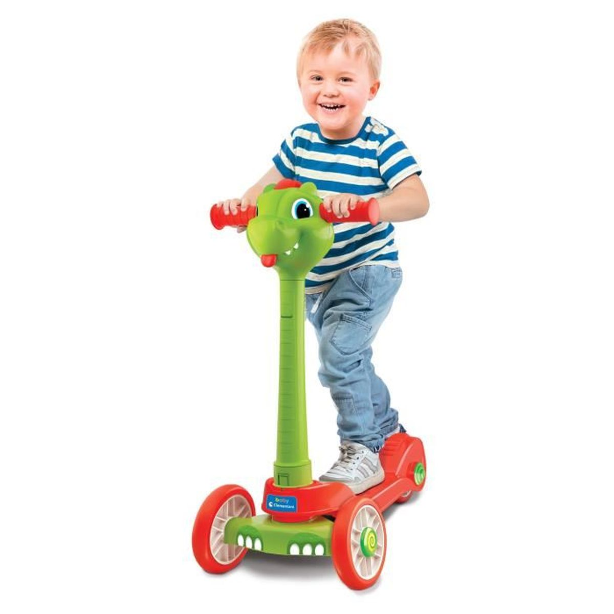 Un bambino su un monopattino verde e rosso con testa di coccodrillo. Sfondo bianco.
