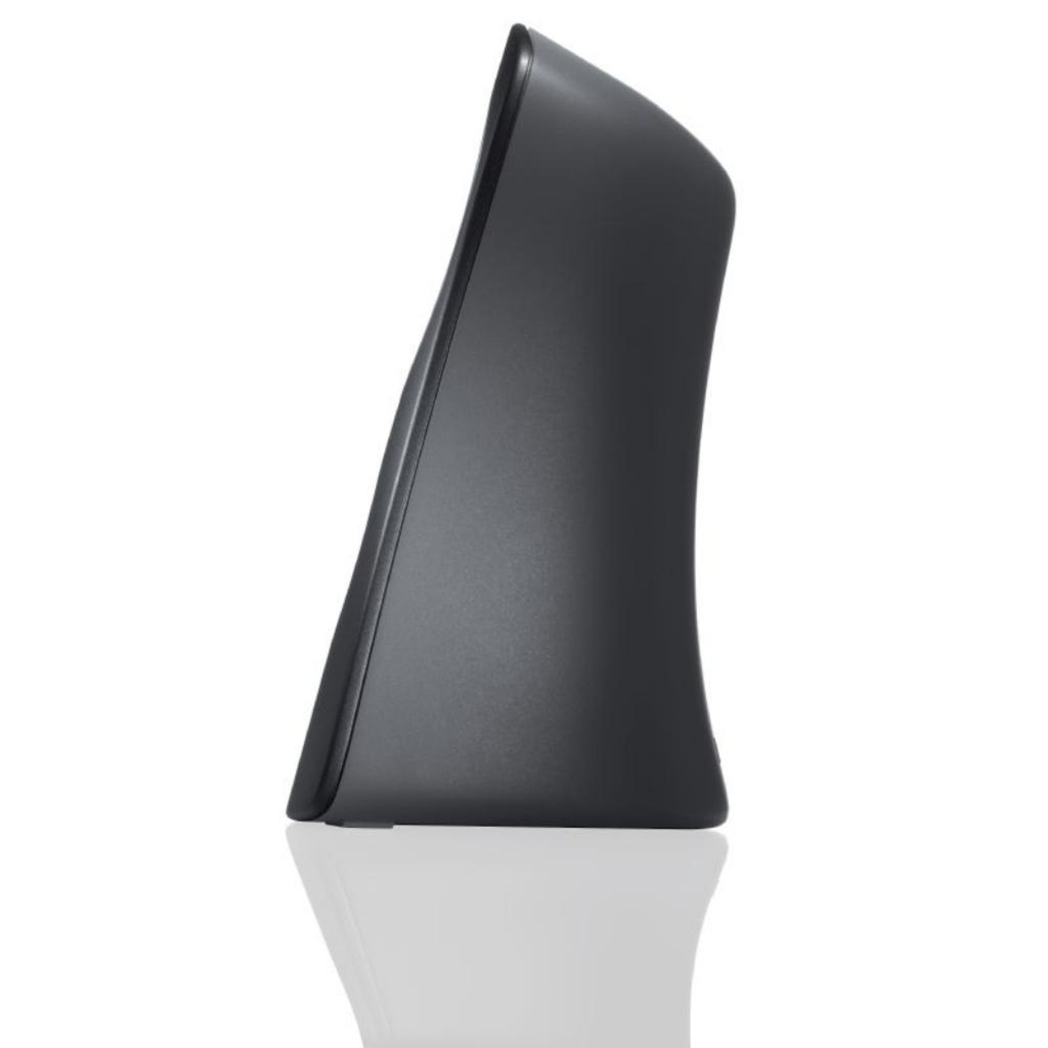 Black speaker on a white surface, with a glossy, curved design.
