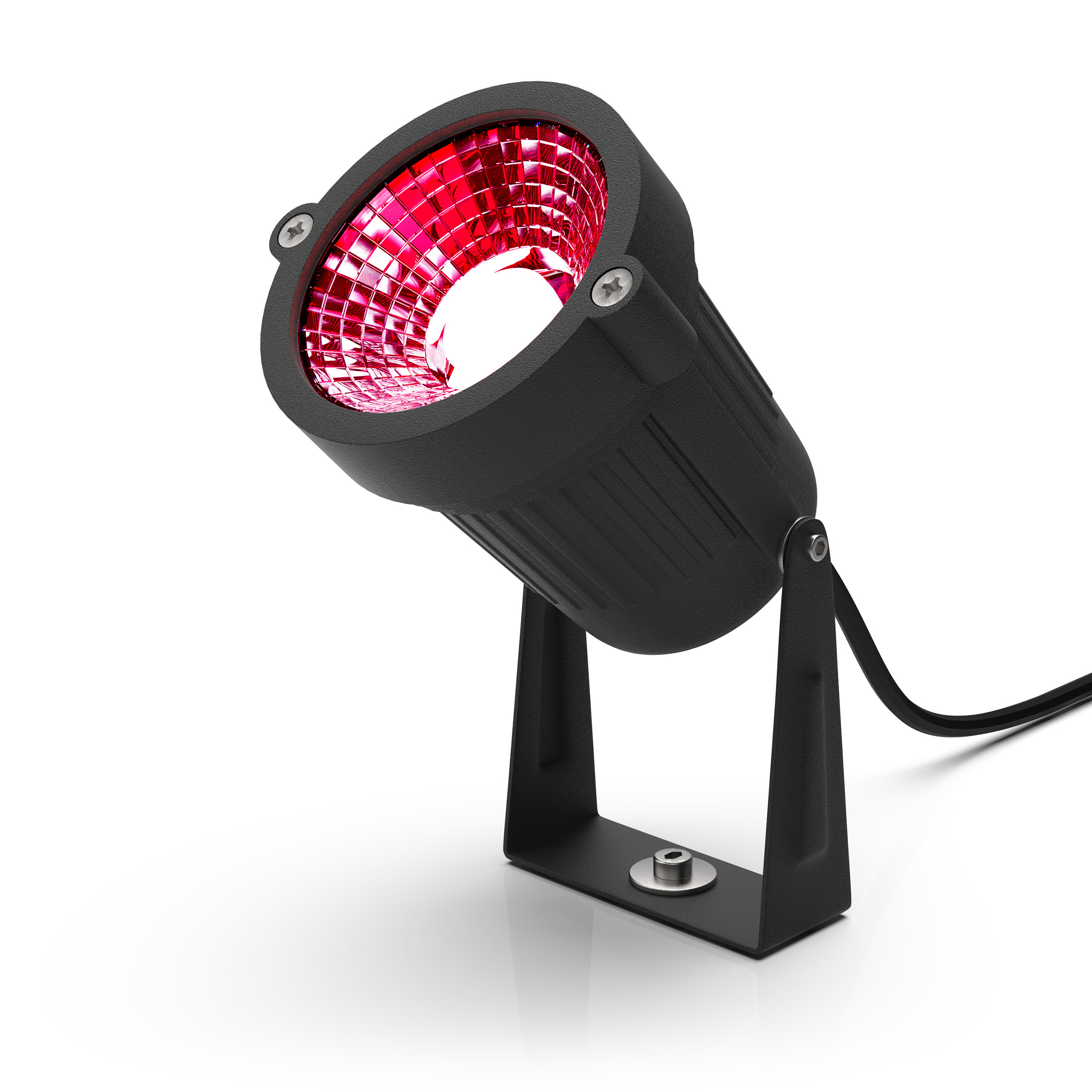 Black spotlight with red light shining, angled upward on a white surface.