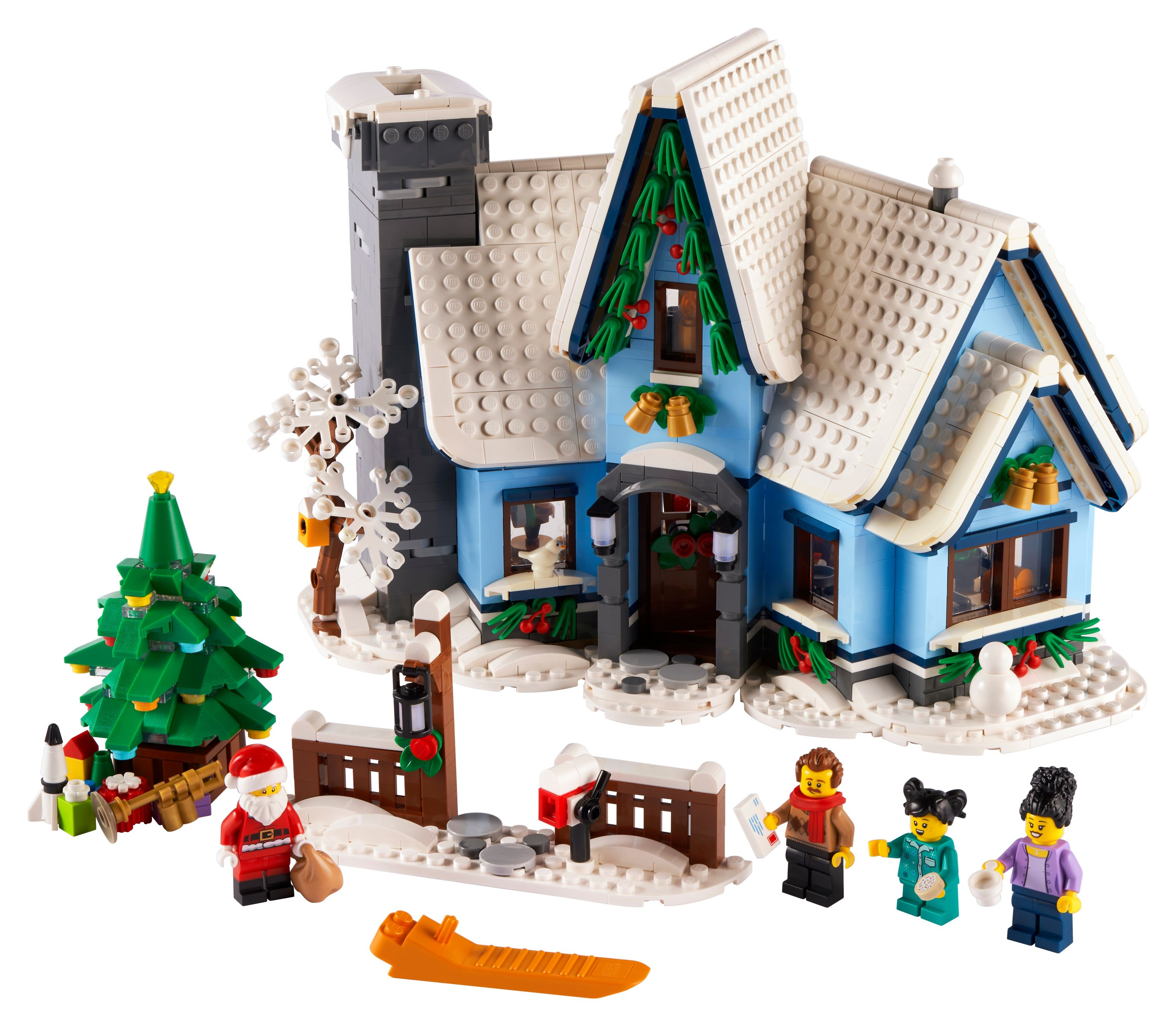 Ein Lego-Weihnachtshaus mit Figuren, einem Weihnachtsbaum und einem Schlitten. Es ist eine Schneeszene.