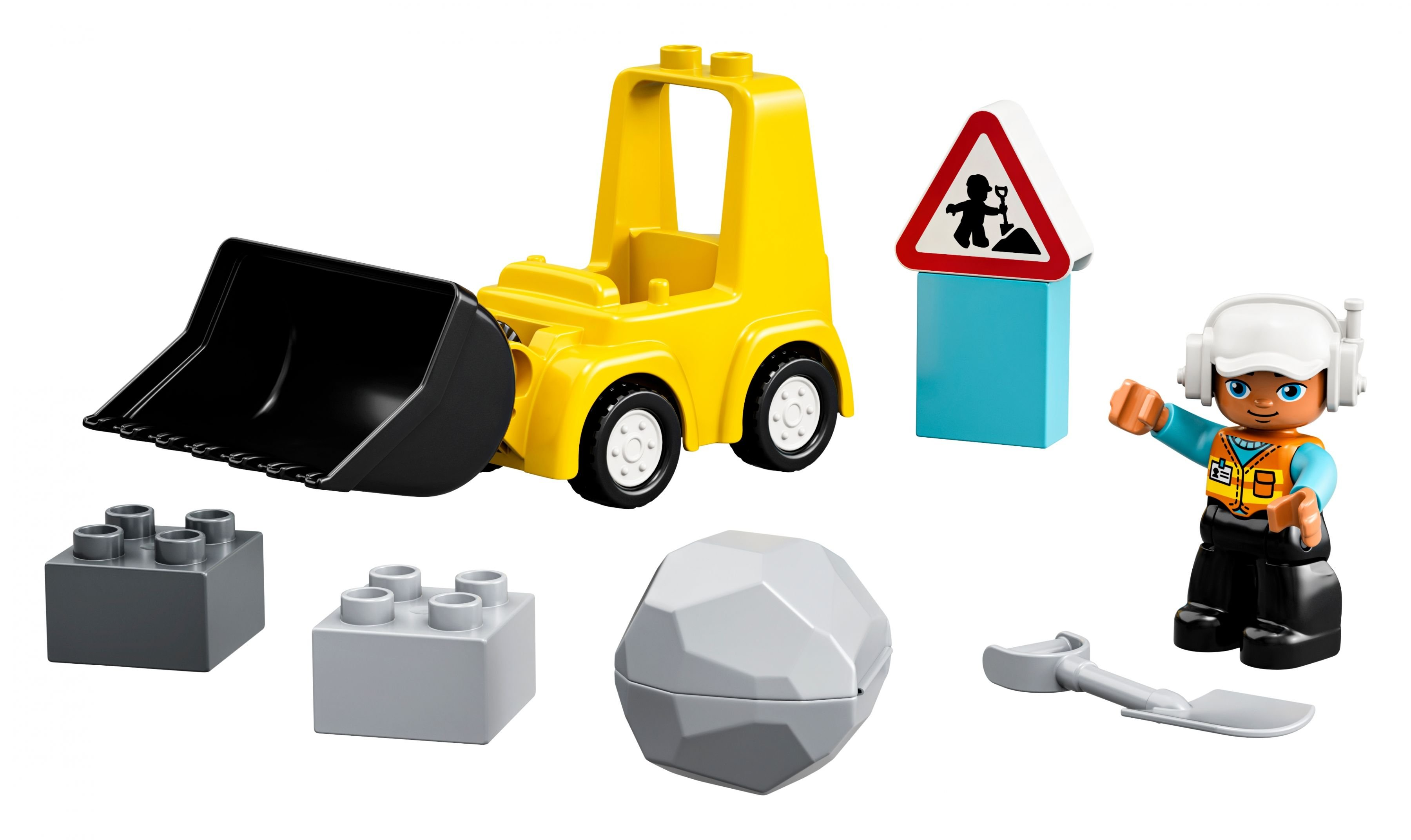 Ein gelbes Spielzeug-Frontlader, Bauarbeiterfigur, Schild, Blöcke und ein Felsen.
