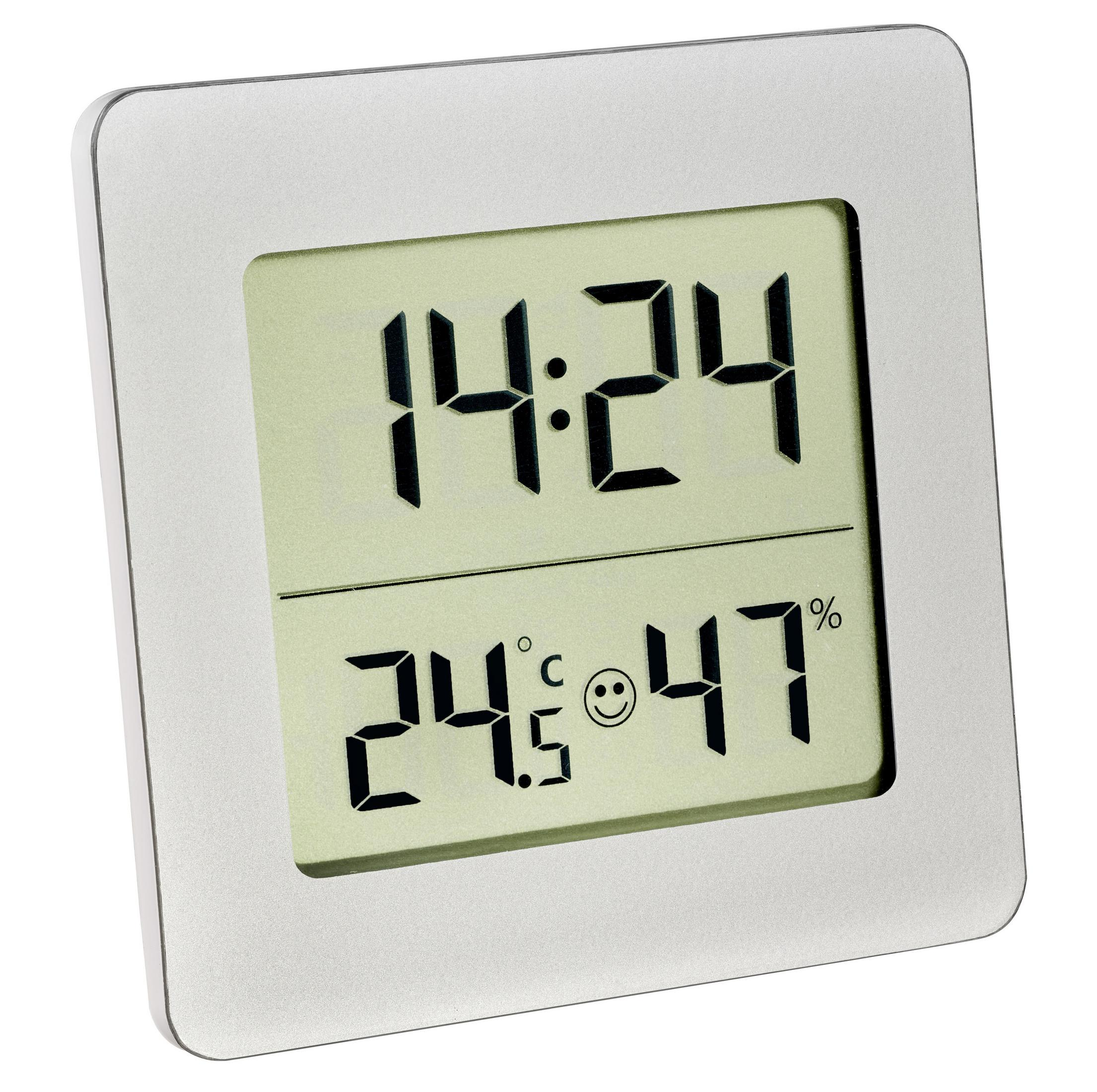 Digitaluhr mit Zeit, Temperatur und Luftfeuchtigkeit auf hellgrünem Hintergrund.