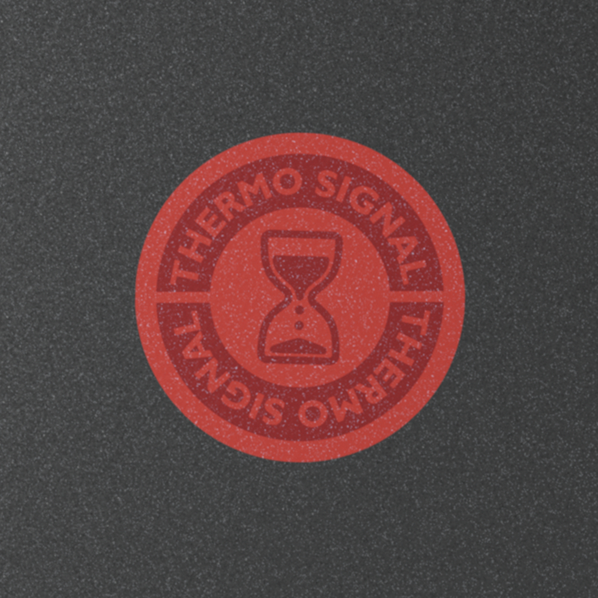Close-up of a red Thermo-Signal logo inside a black pan. Hourglass symbol.