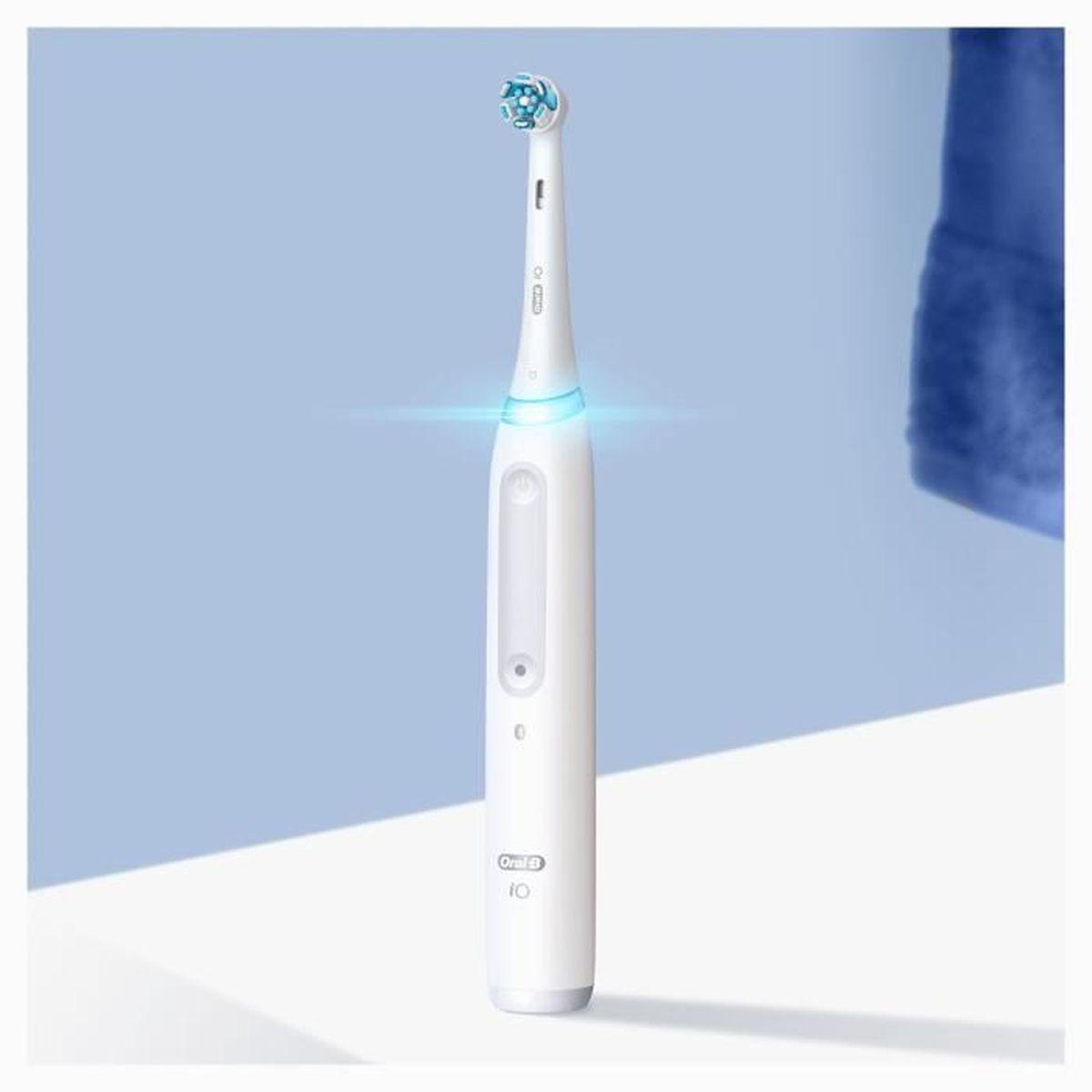 Eine weiße elektrische Zahnbürste mit blauem Licht und einem Bürstenkopf.