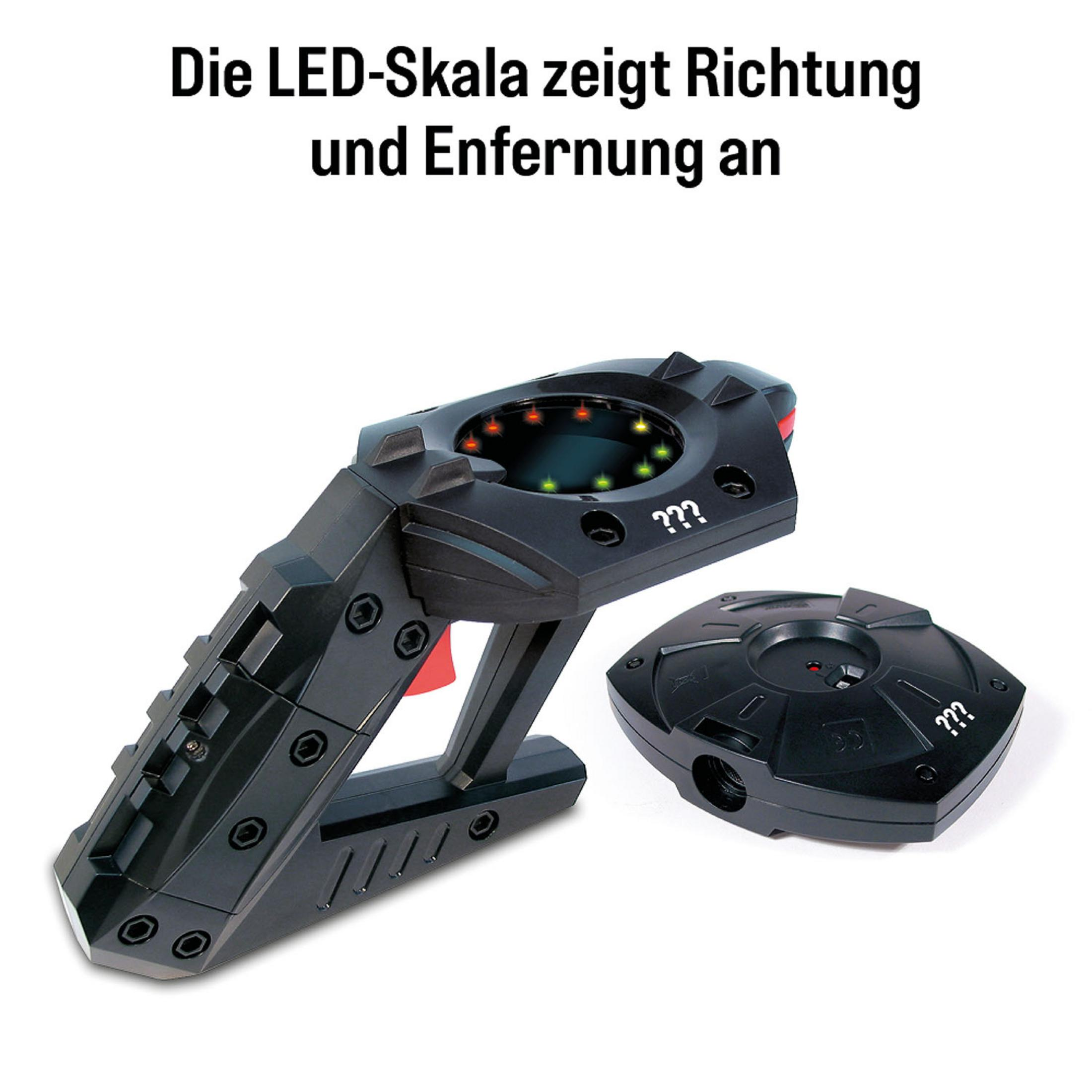 Schwarzes Spielzeug mit rotem Knopf und Lichtern. Ein zweites Teil daneben. Text oben: Richtung und Entfernung.