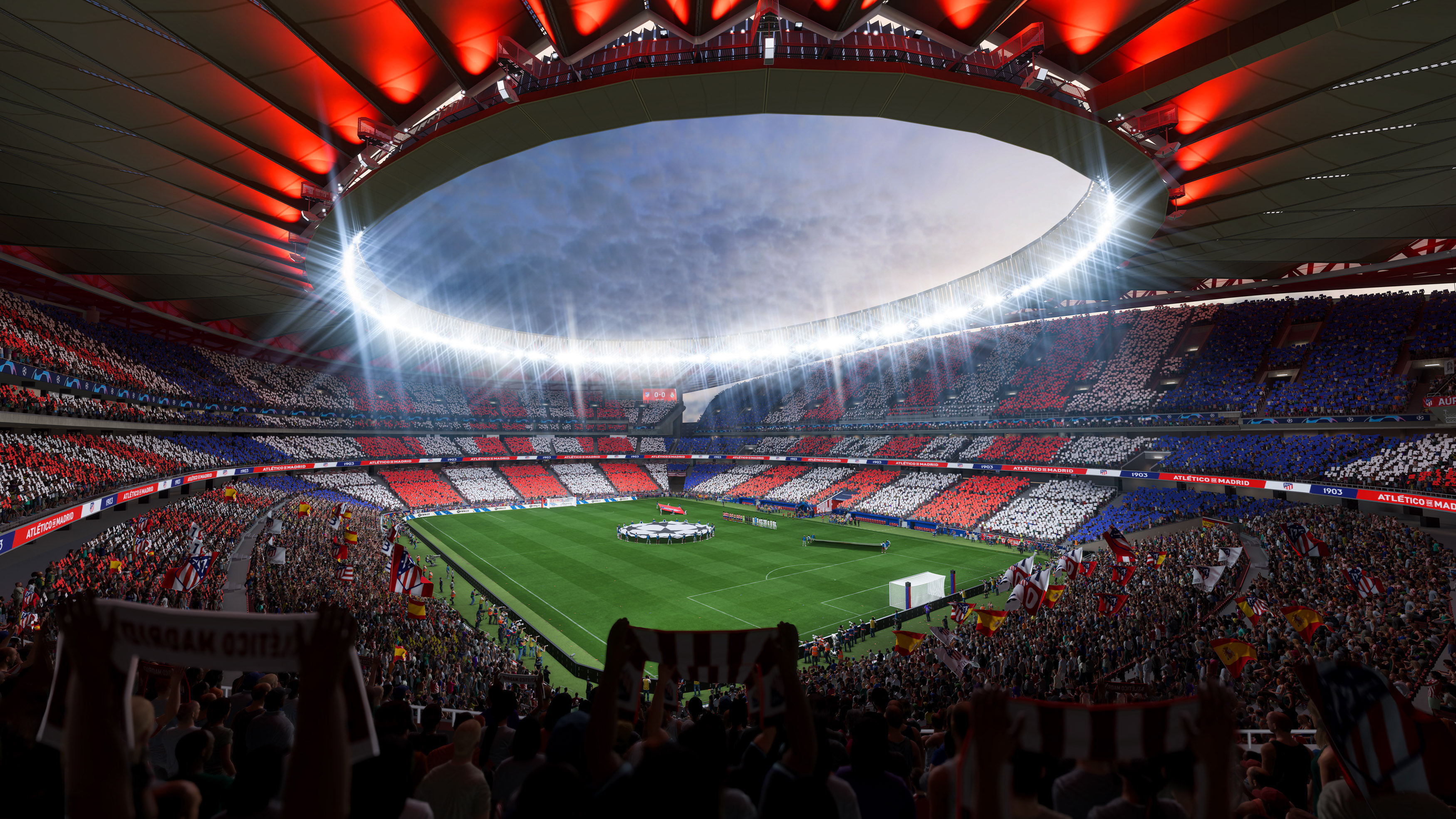 Menschenmenge in einem Stadion mit roten und weißen Farben, grünem Feld und hellem Licht.