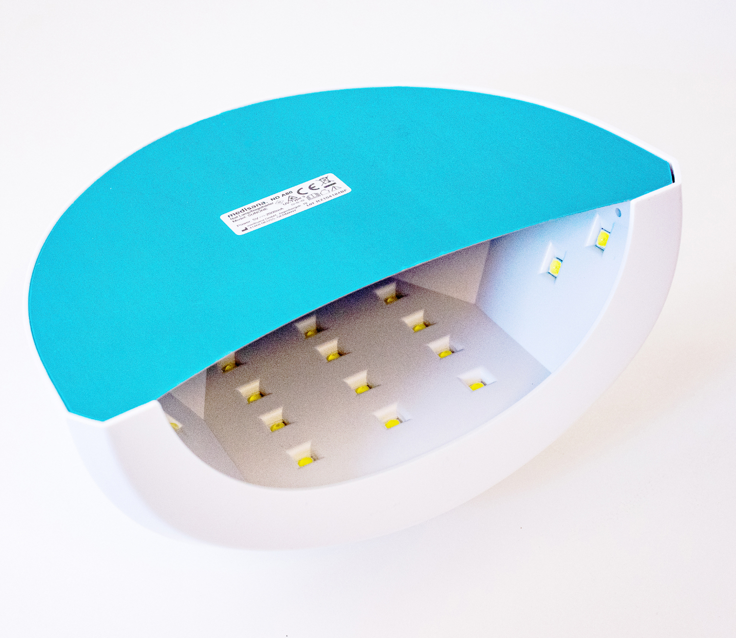 Een witte en blauwgroene nagelverhardingslamp, met zichtbare interne LED-lampjes.