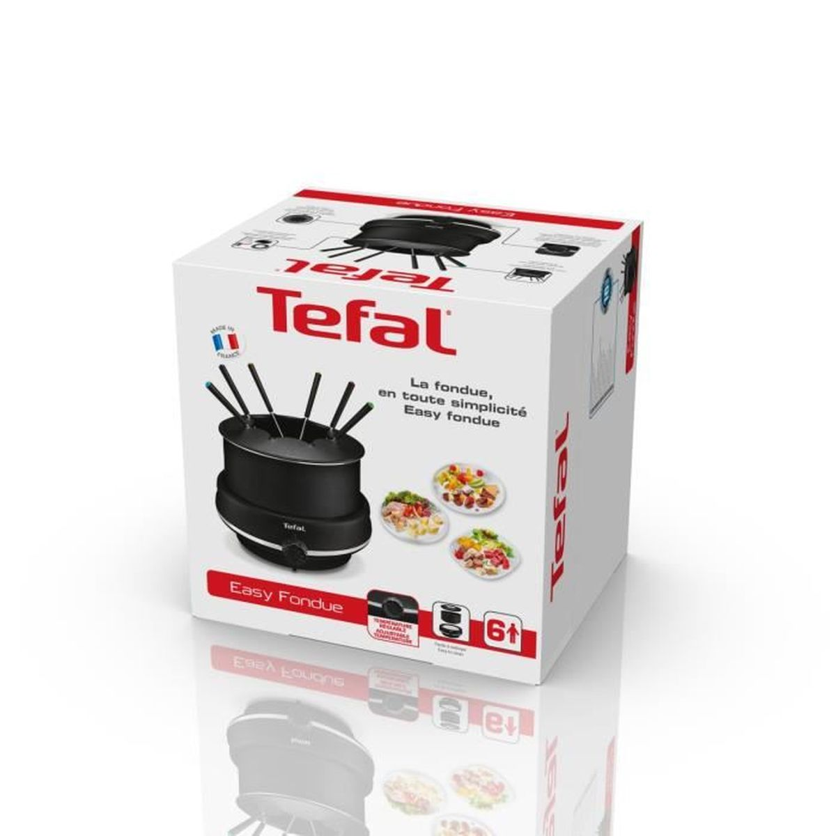 Białe pudełko Tefal Easy Fondue z garnkiem do fondue i widelcami. Dania z jedzeniem w tle.