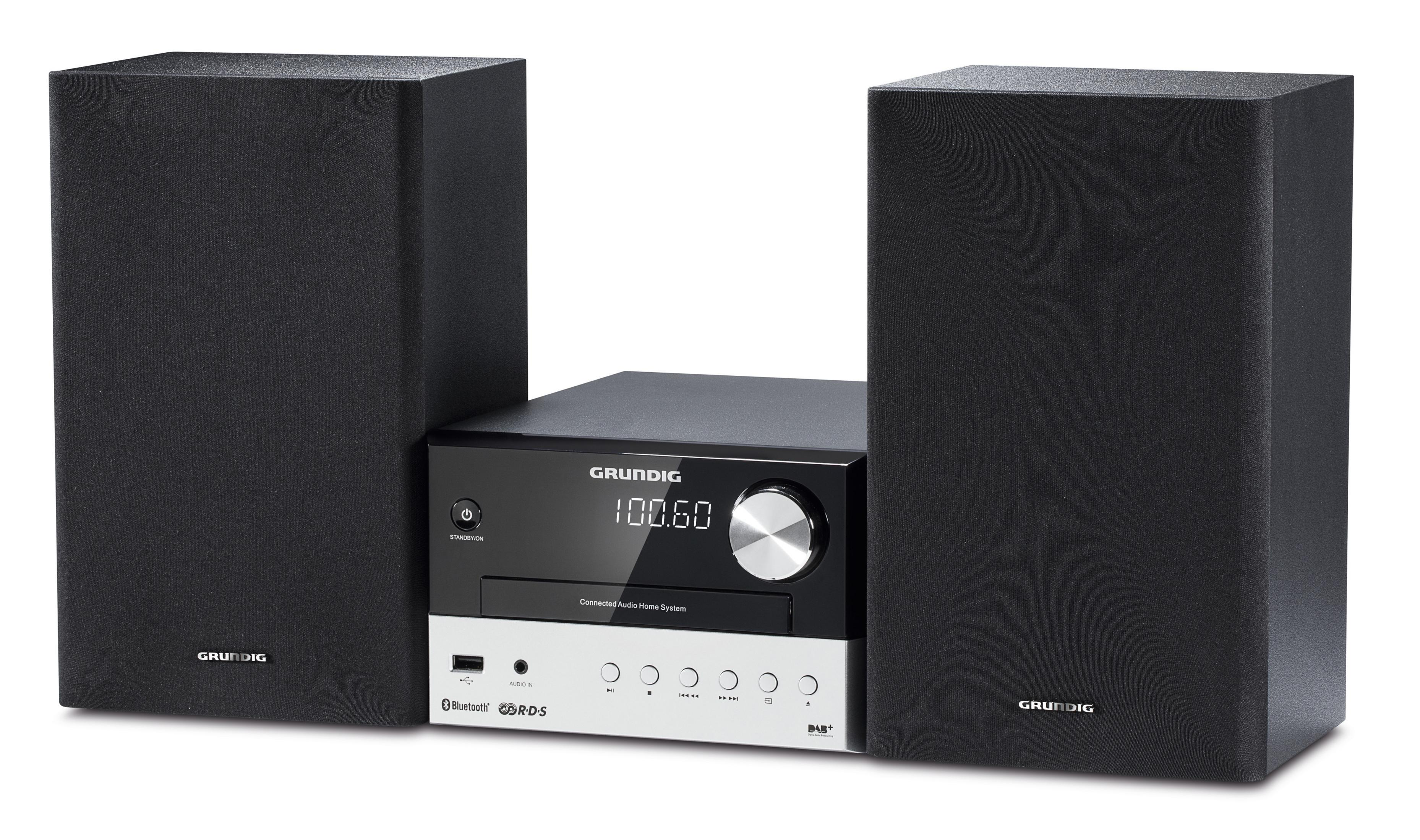 Sistema de audio negro y plateado con dos altavoces negros. La pantalla muestra la radio.