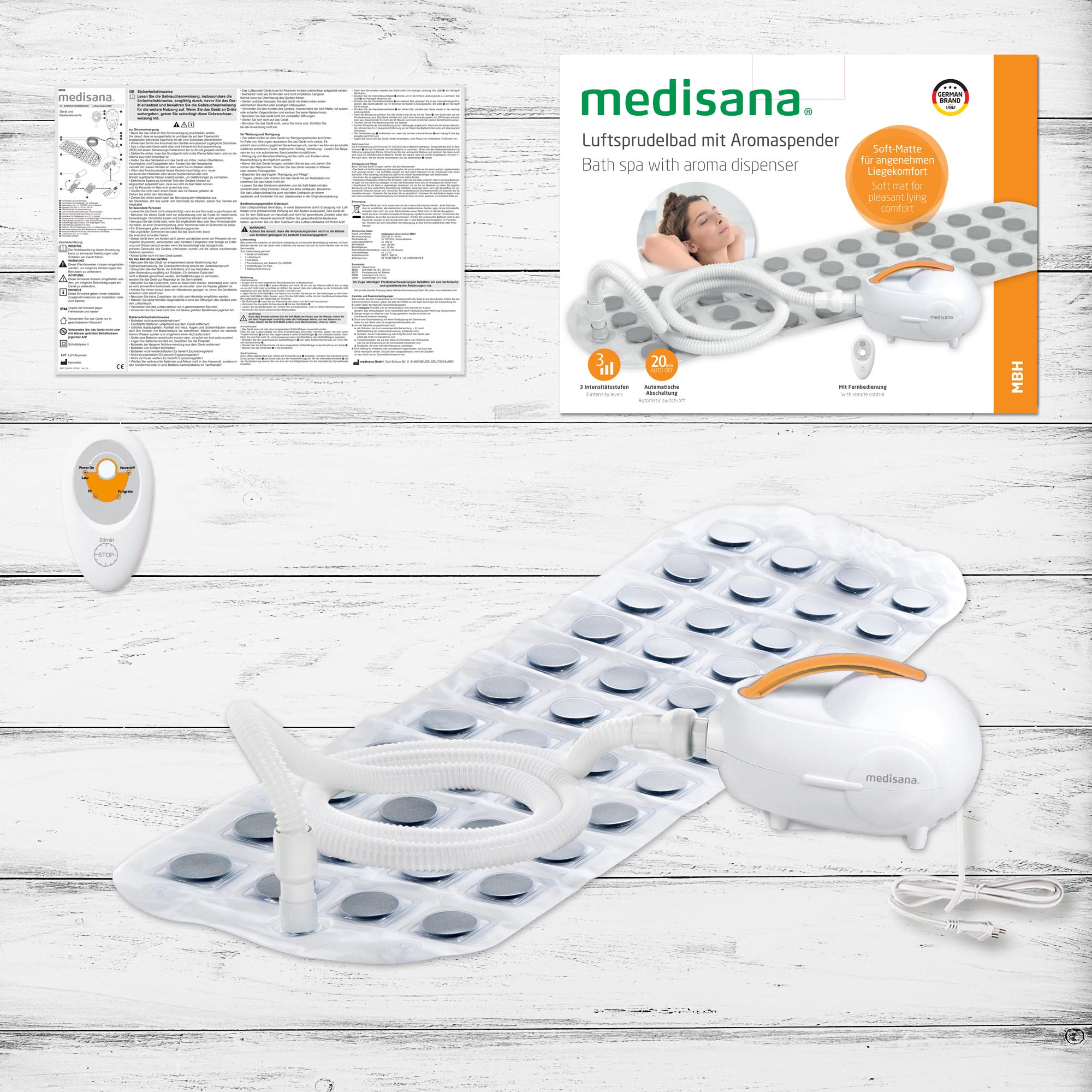 Een witte badspa met een dispenser, afstandsbediening en instructies.