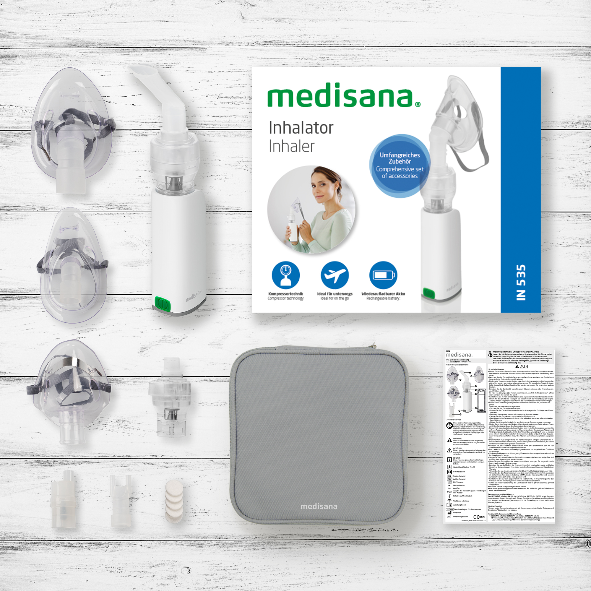 Medisana inhaler set. Includes inhaler, masks, accessories, and a carrying case, all on wood.