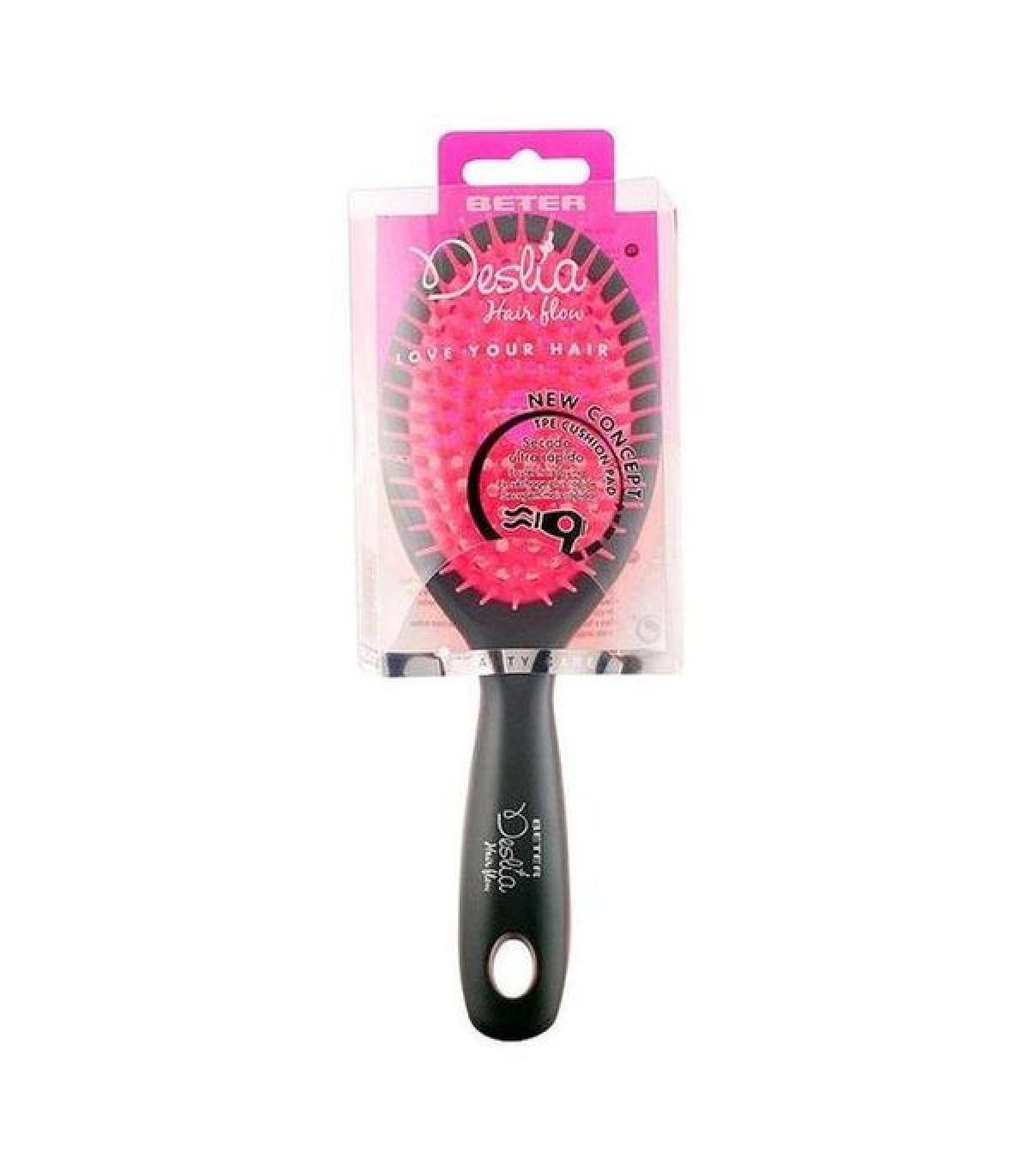 Un cepillo de pelo rosa y negro en un paquete, con el nombre de la marca y detalles del diseño.