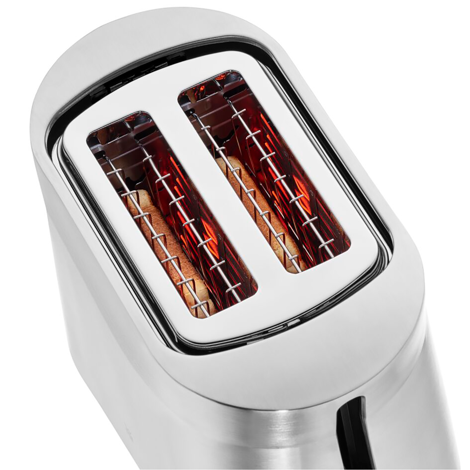 Zbliżenie chromowanego tostera z dwoma otworami. Tosty w środku, świecące na czerwono.