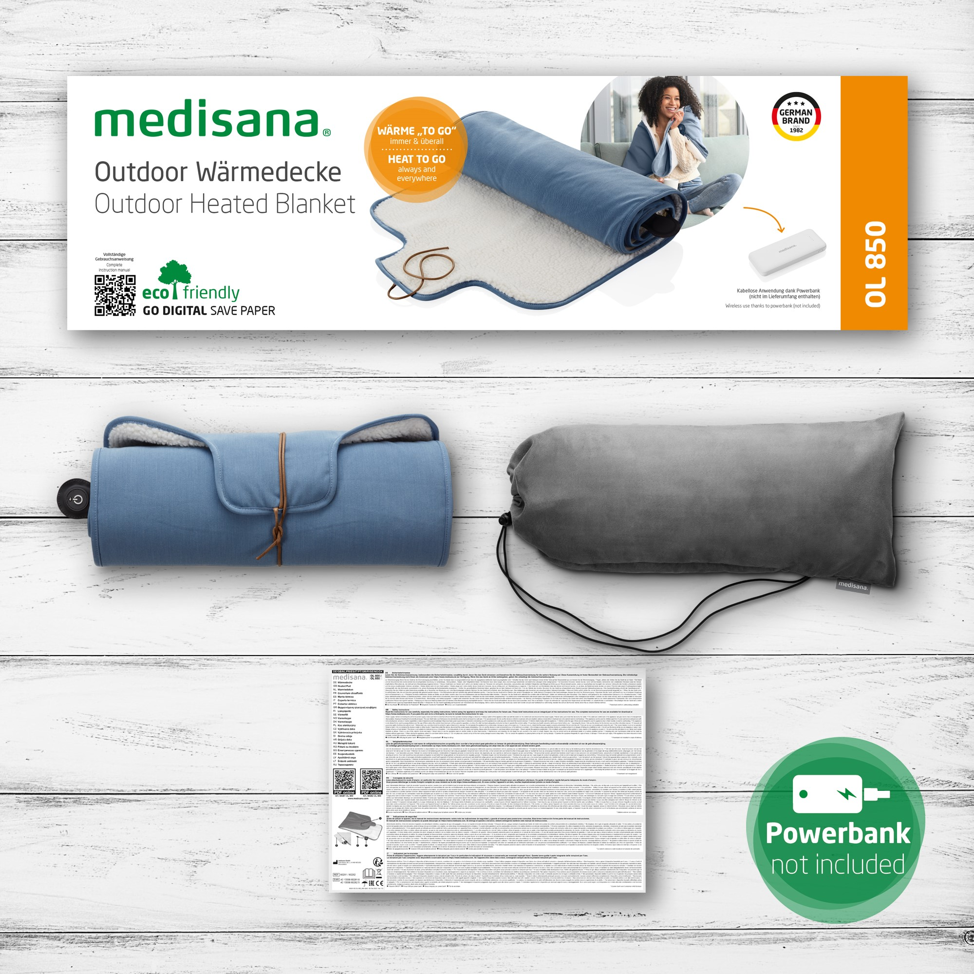 Manta térmica para exteriores enrollada con power bank mostrada.