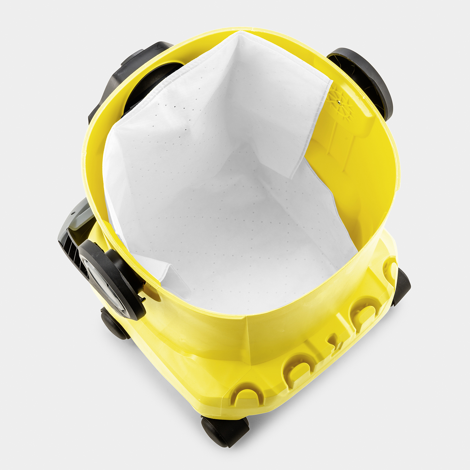 Żółty odkurzacz z białym workiem filtracyjnym. Tło białe.