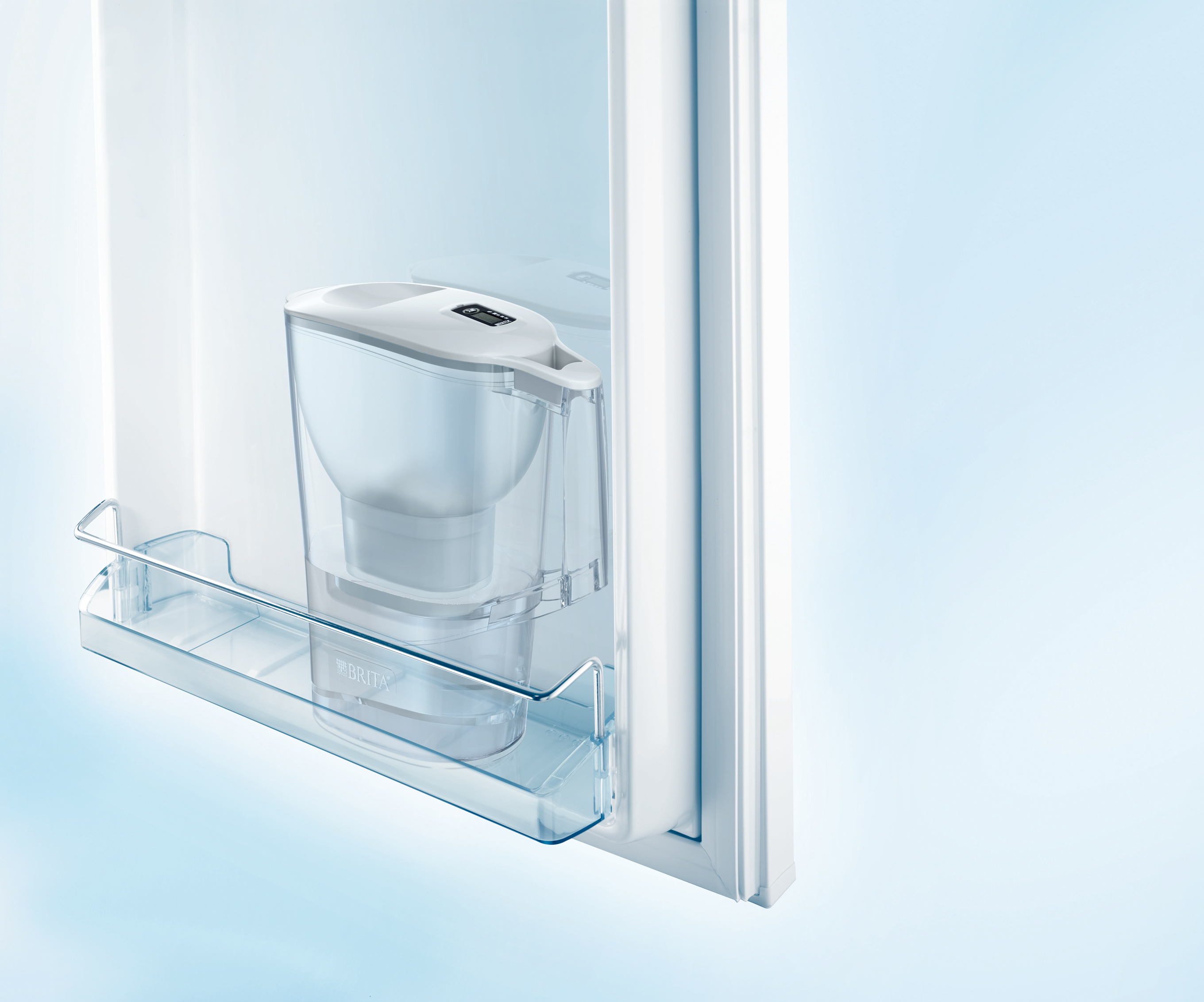 Brita water filter jug inside a refrigerator. Visible on the shelf.